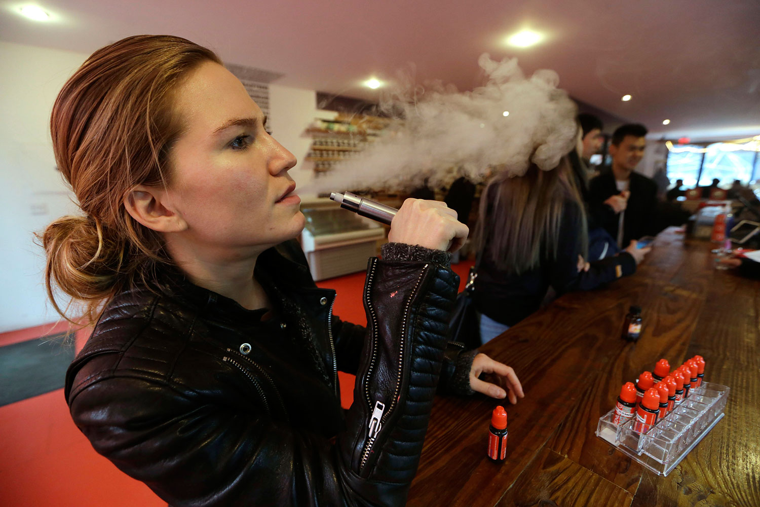 Talia Eisenberg, co-founder of the Henley Vaporium, uses her vaping device in New York, Feb. 20, 2014.
