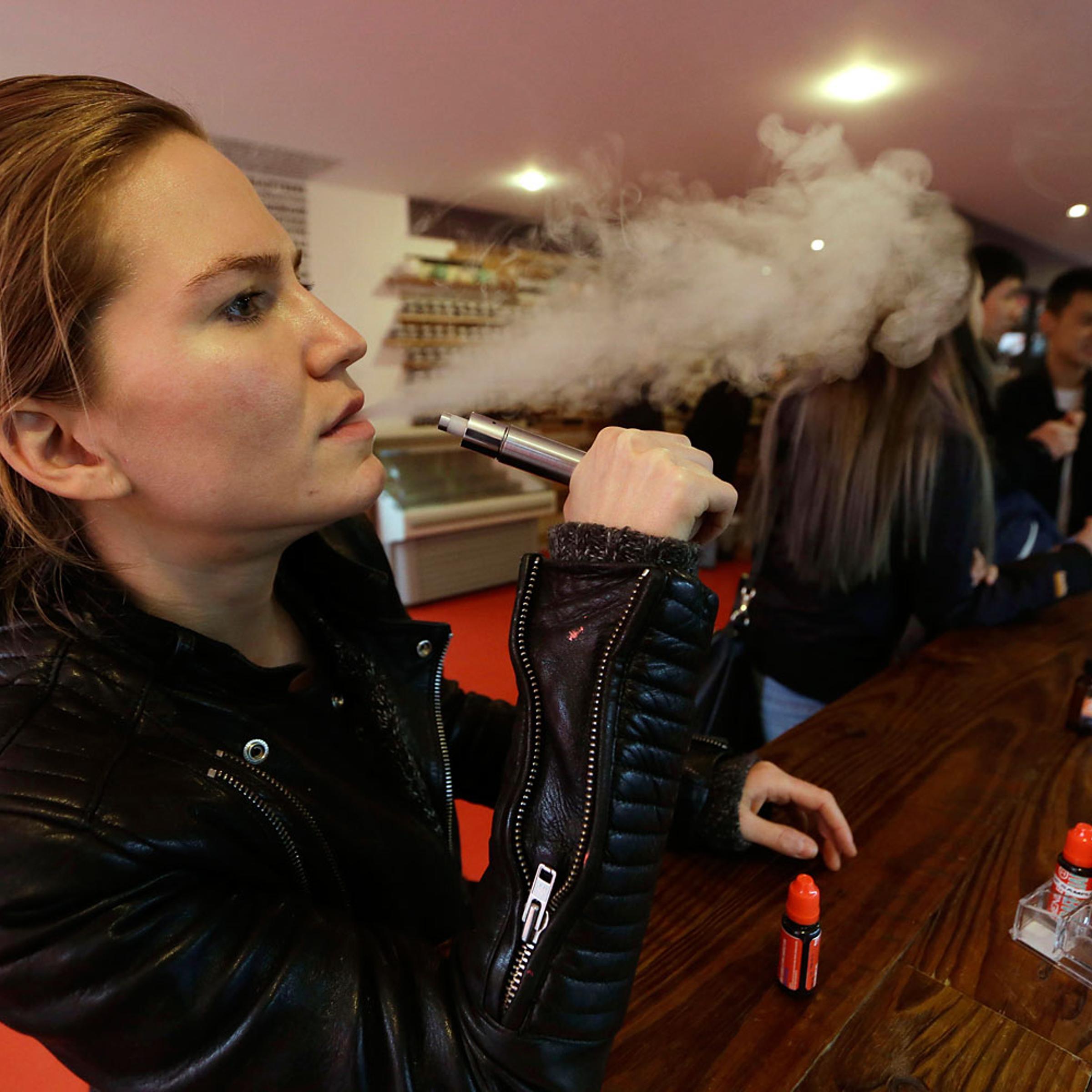 Talia Eisenberg, co-founder of the Henley Vaporium, uses her vaping device in New York, Feb. 20, 2014.