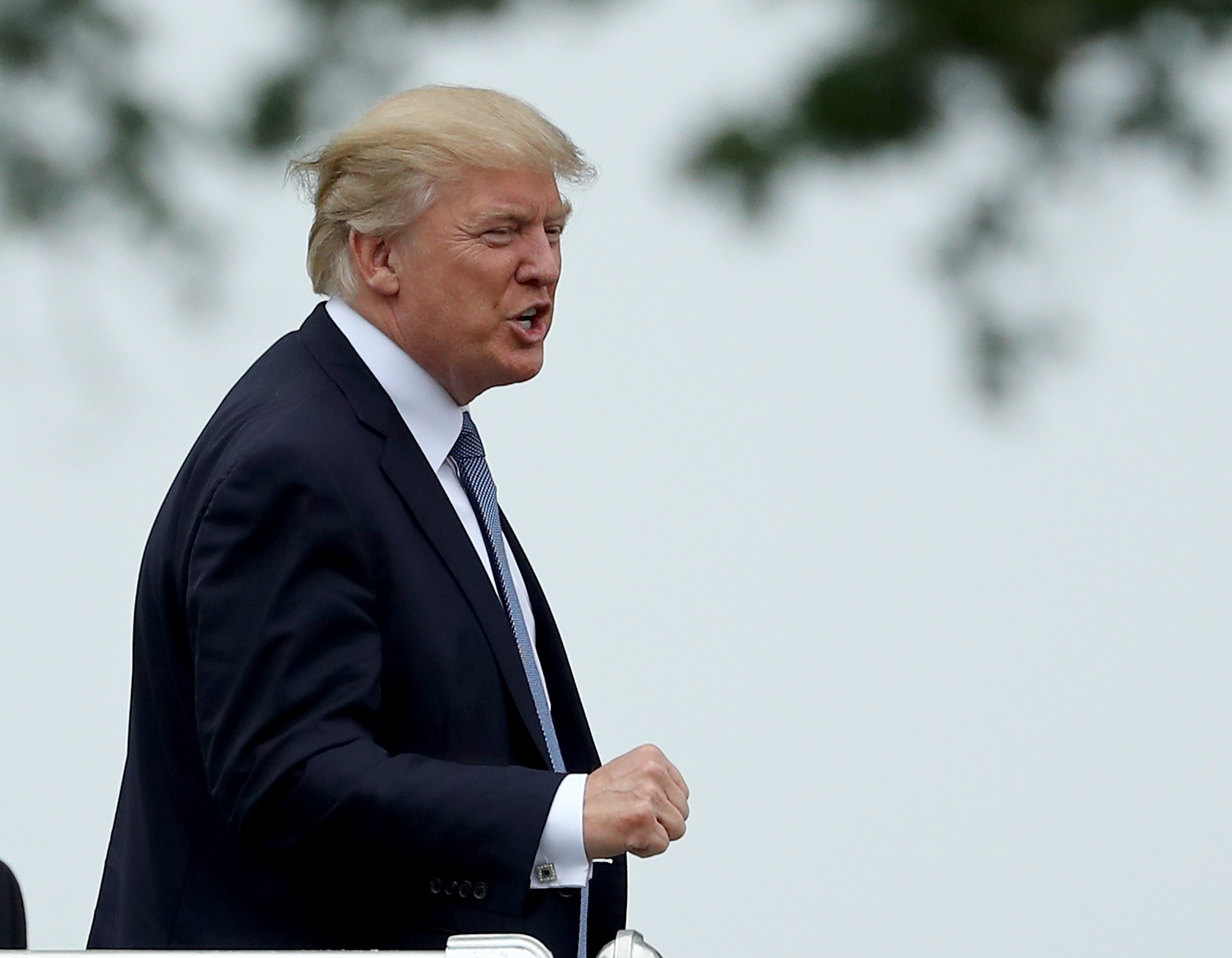 President Donald Trump acknowledges the patrons in the clubhouse as he leaves the U.S. Women's Open round two on July 14, 2017 at Trump National Golf Course in Bedminster, New Jersey.