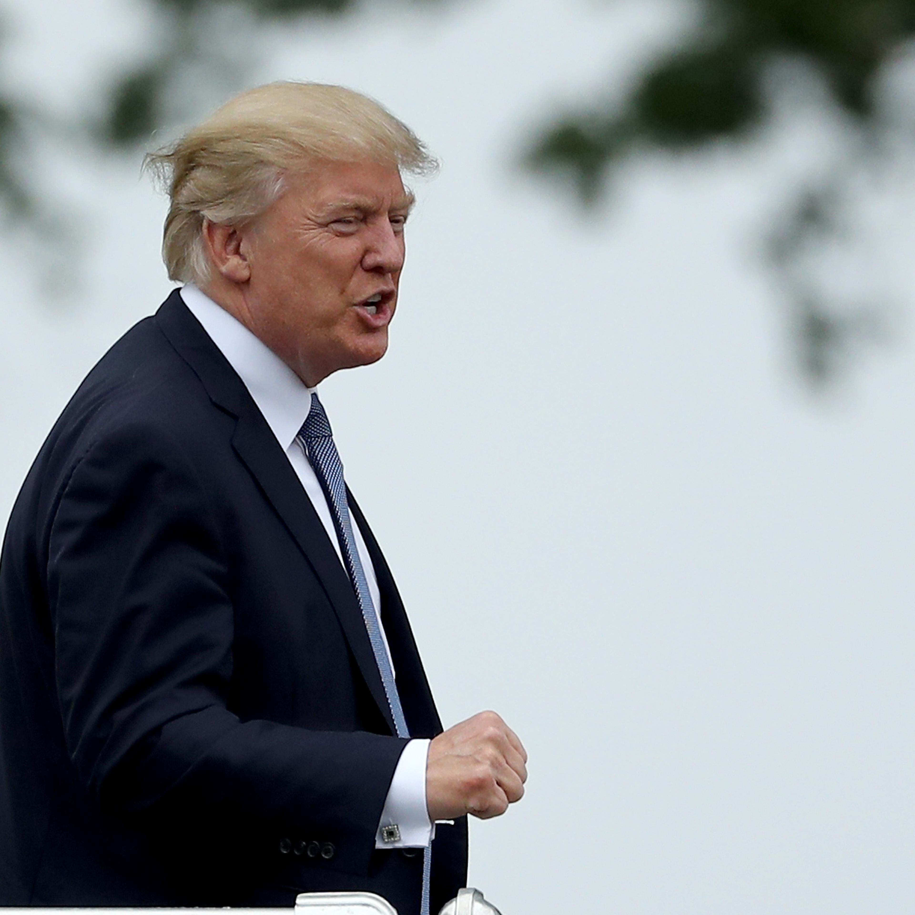 President Donald Trump acknowledges the patrons in the clubhouse as he leaves the U.S. Women's Open round two on July 14, 2017 at Trump National Golf Course in Bedminster, New Jersey.