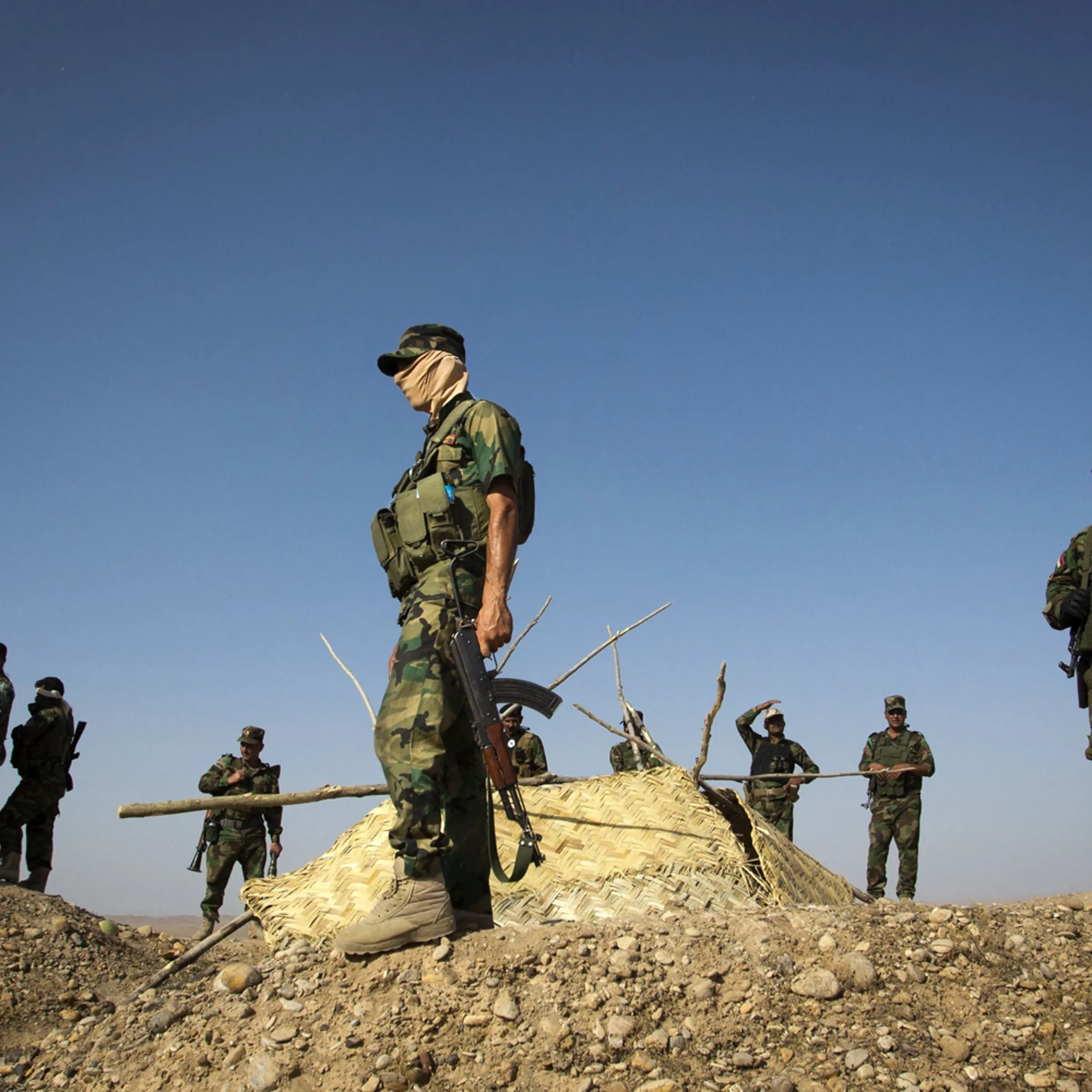 Members of Kurdish Peshmerga forces stand atop a hill during clashes with militants of the Islamic State of Iraq and Syria (ISIS) jihadist group in Jalawla in the Diyala province, on June 14, 2014.