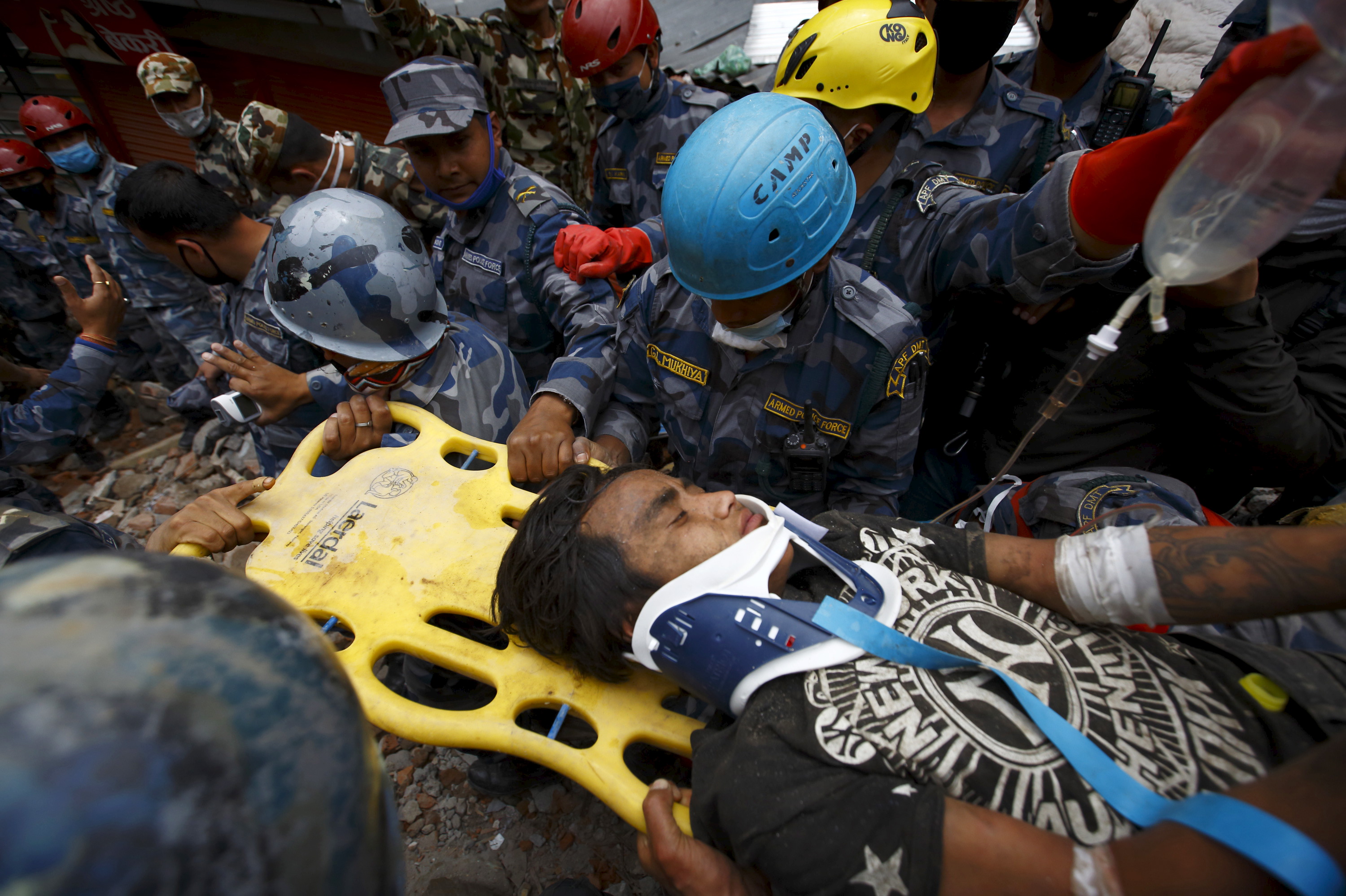 Earthquake survivor Pema Lama is rescued by the Armed Police Force from the collapsed Hilton Hotel, a result of an earthquake in Kathmandu