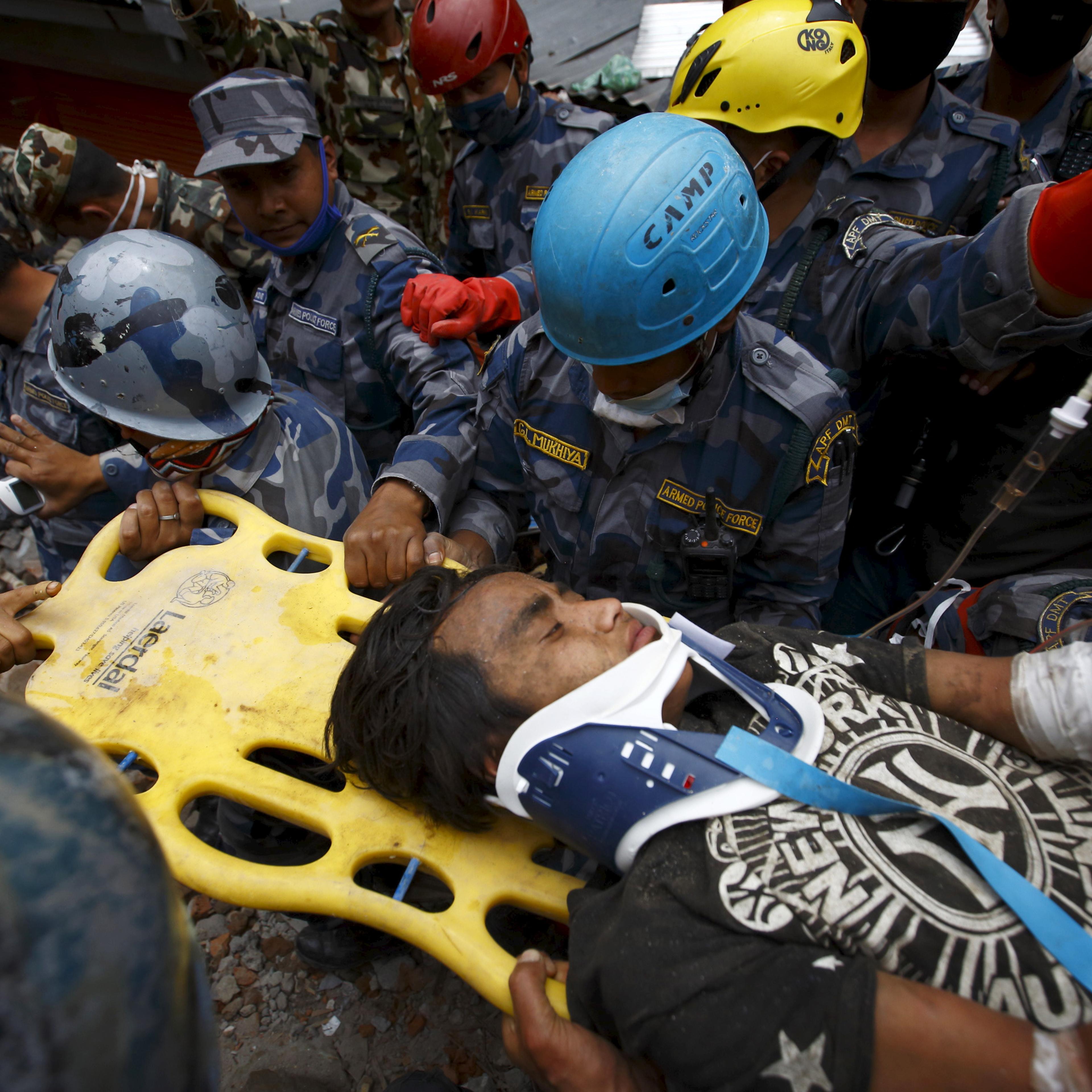 Earthquake survivor Pema Lama is rescued by the Armed Police Force from the collapsed Hilton Hotel, a result of an earthquake in Kathmandu