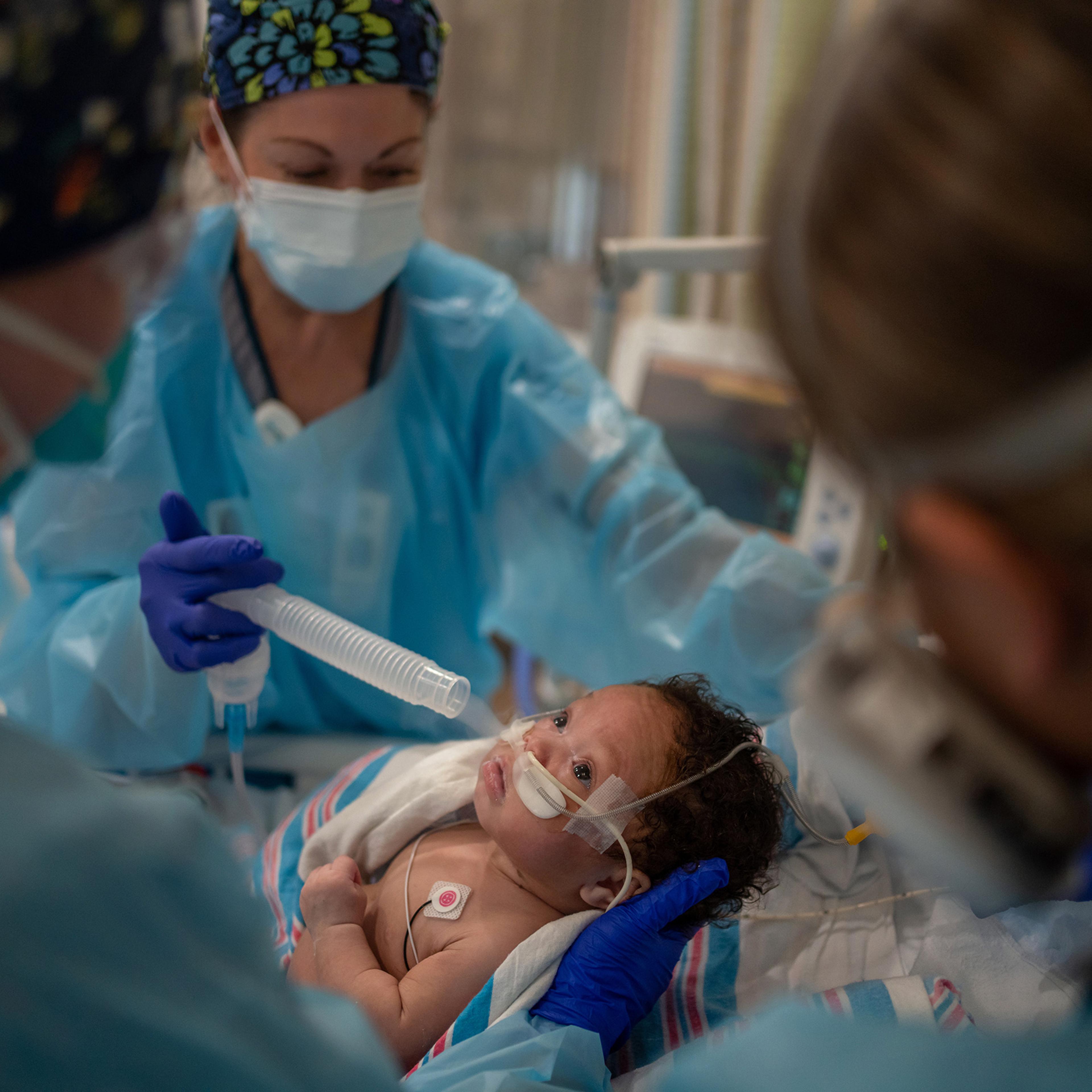 Respiratory therapist Diane Gelpi administers oxygen to two-month-old Carvase Perrilloux after he was taken off a ventilator at Children’s Hospital New Orleans on Aug. 20, 2021.