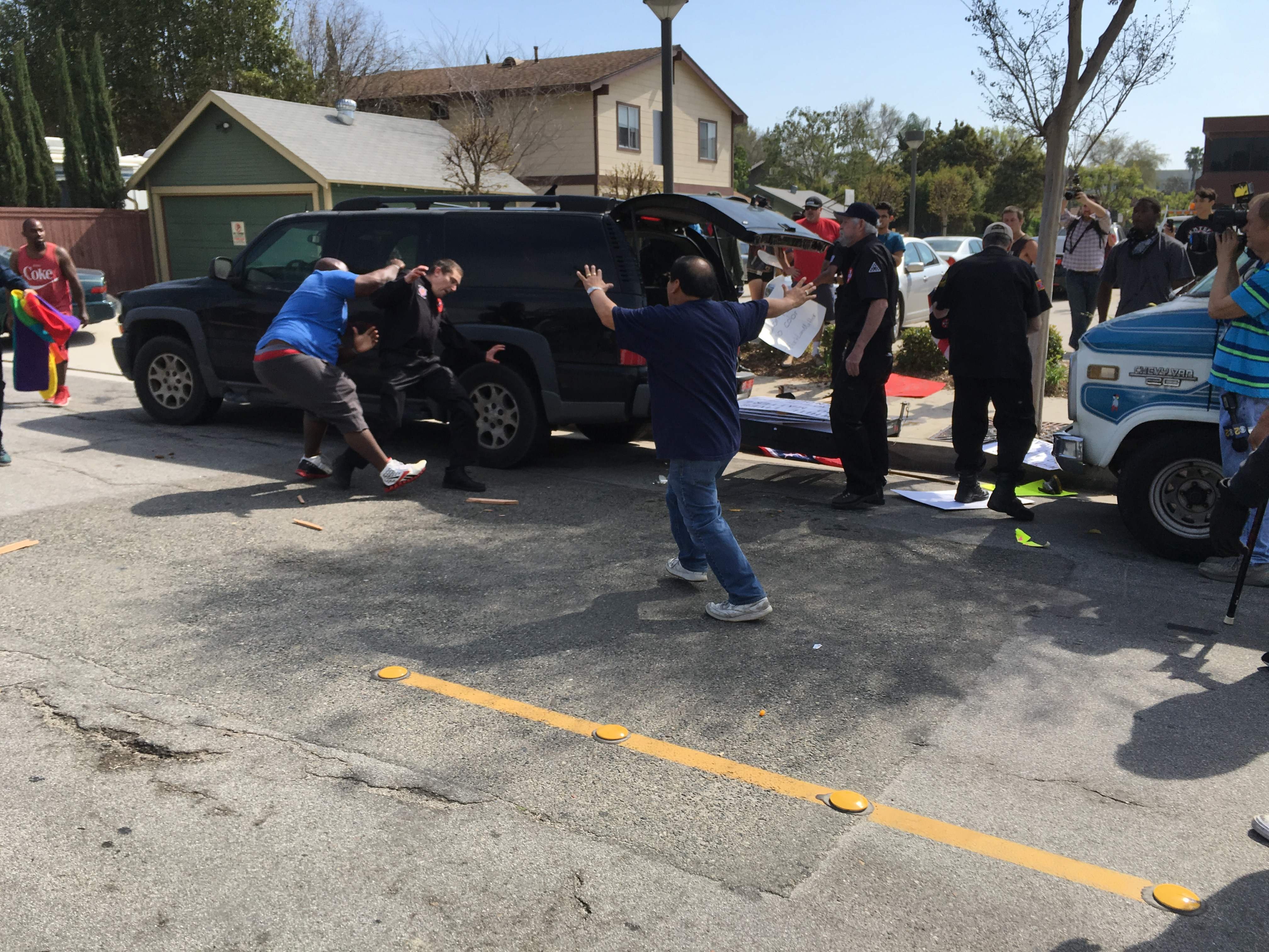 This handout picture obtained courtesy of the Center for the Study of Hate and extremism shows a counter-protester (L) tackling a member of the Ku Klux Klan during a KKK rally in Anaheim, Calif., Feb. 27, 2016.