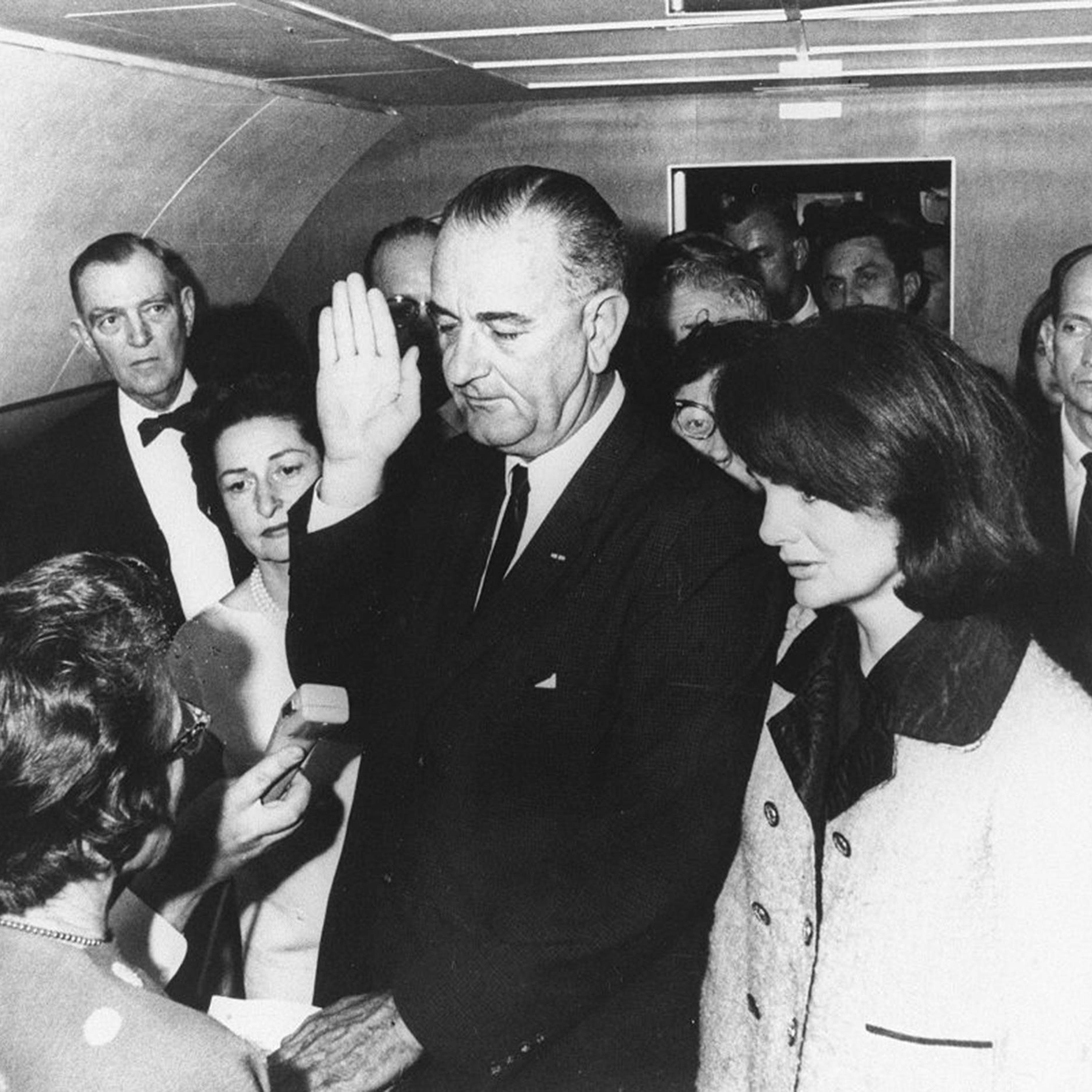 Lyndon B. Johnson is sworn in as President by federal Judge Sarah T. Hughes on Air Force One on Nov. 22, 1963, in Dallas, following the assassination of President John F. Kennedy. He's flanked by Jacqueline Kennedy (right) and wife Lady Bird Johnson (left).