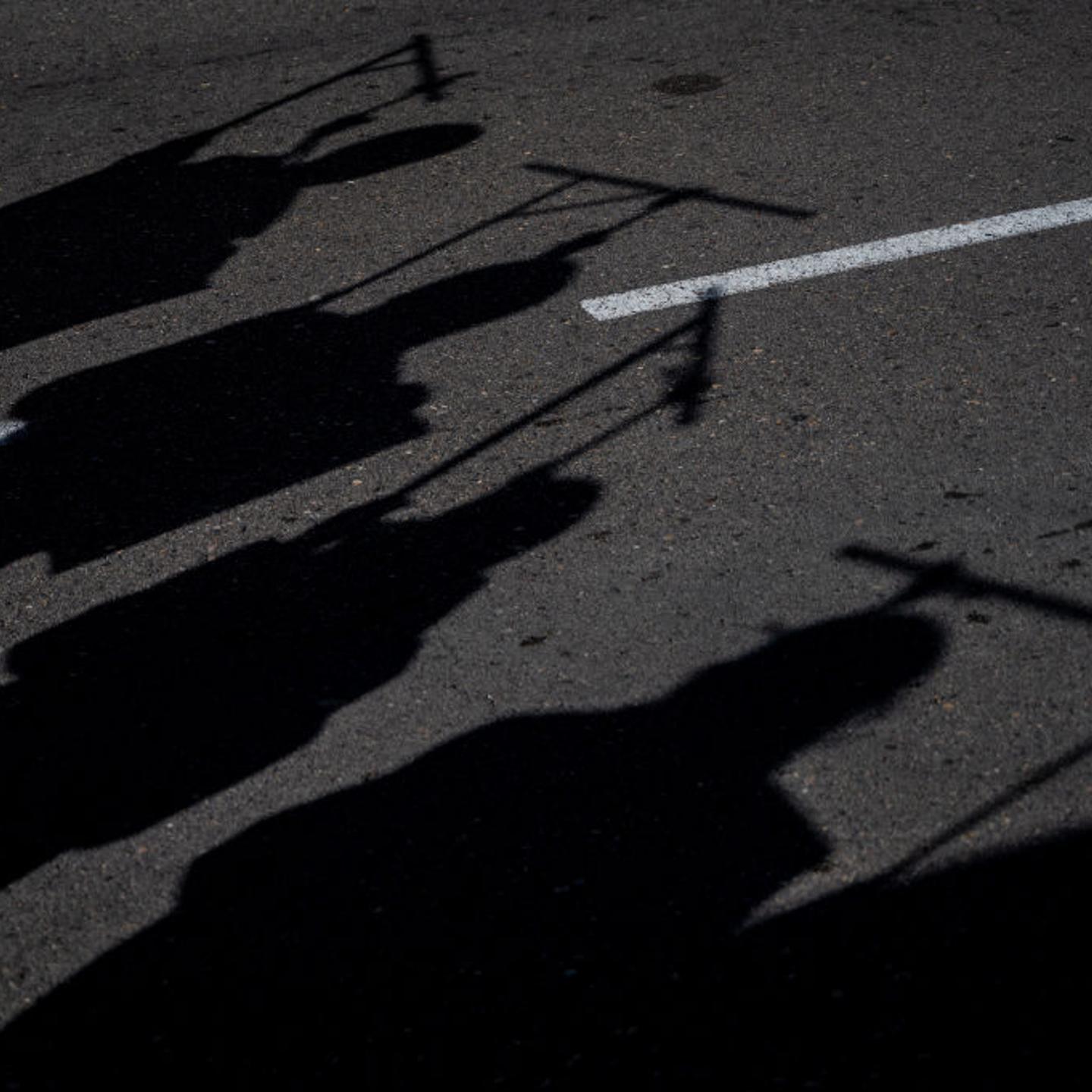 Silhouettes of hanged people are seen during a demonstration