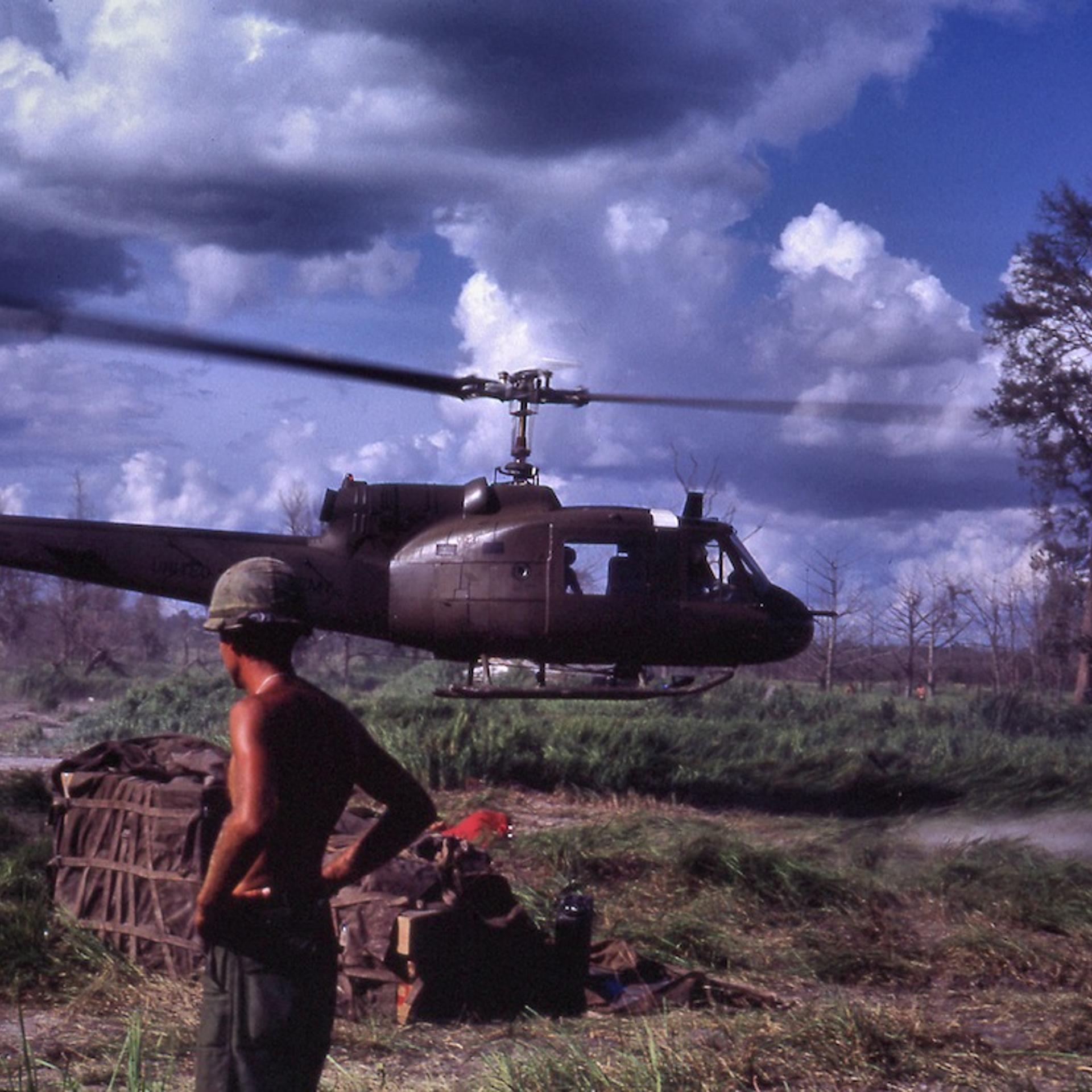 LZ, 1967: "Bell UH-1 Iroquois (Huey “Slick”) helicopter makes a quick troop drop at a Fire Support Base near the Cambodian border without touching down."