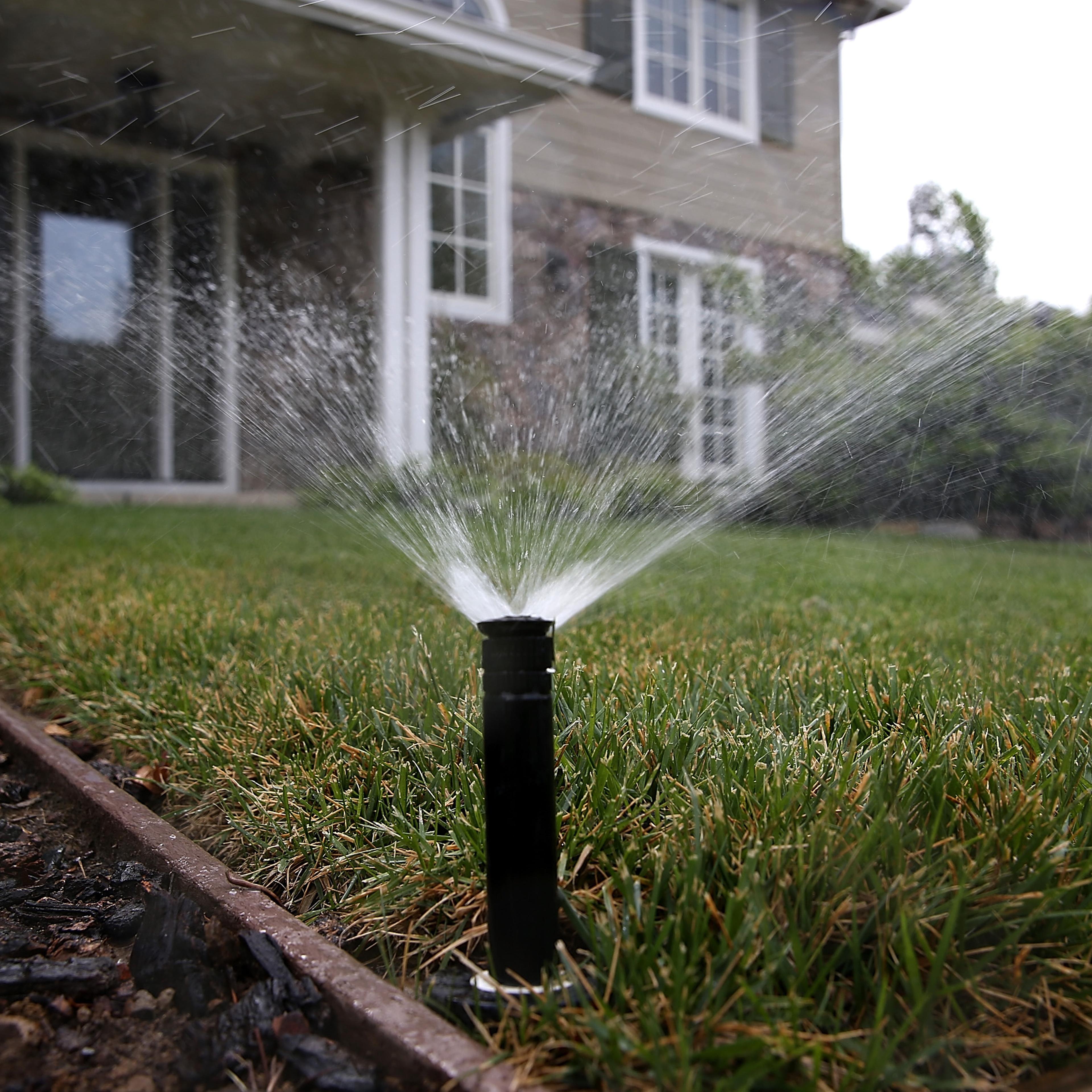 A sprinkler waters a lawn on April 7, 2015 in Walnut Creek, California.