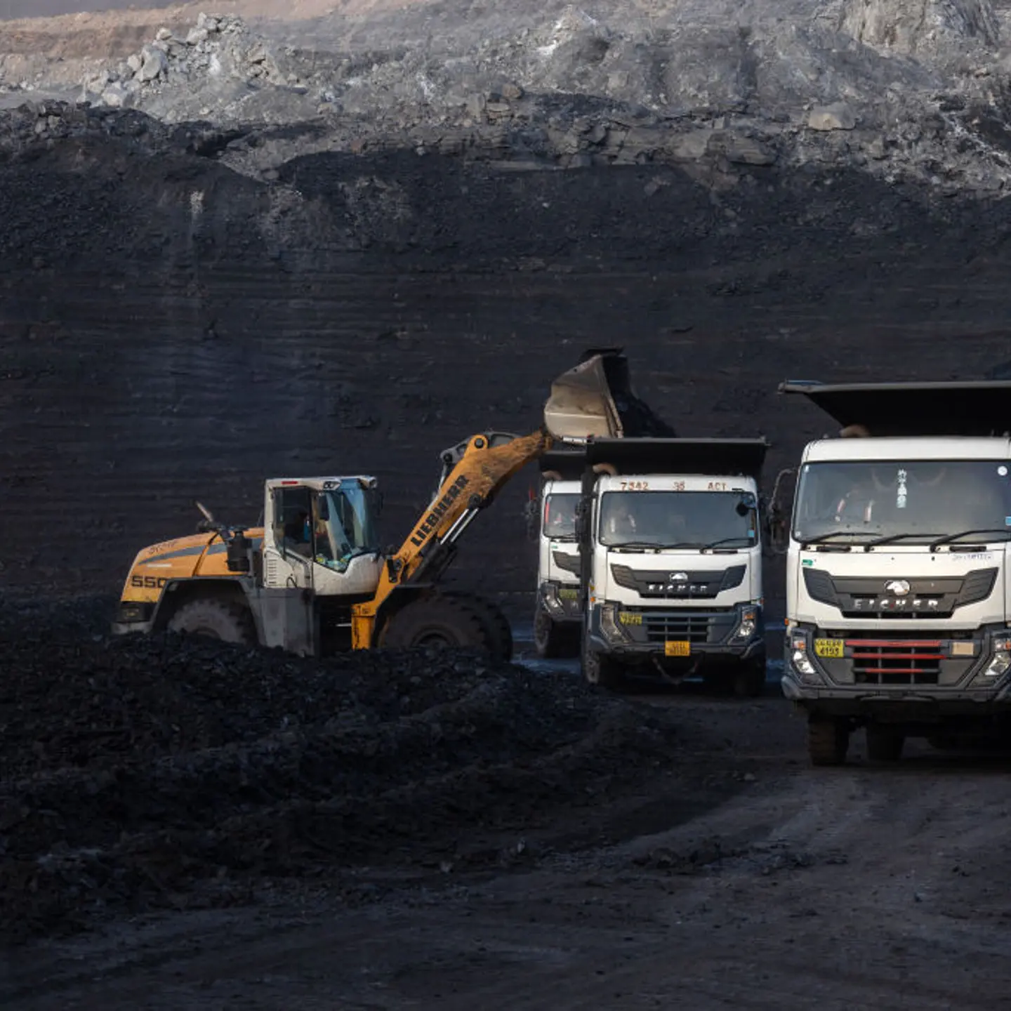 A loader fills dump trucks at the coal mine, operated by South Eastern Coalfields Ltd., in Gevra, Chhattisgarh, India, on Wednesday, May 10, 2023.