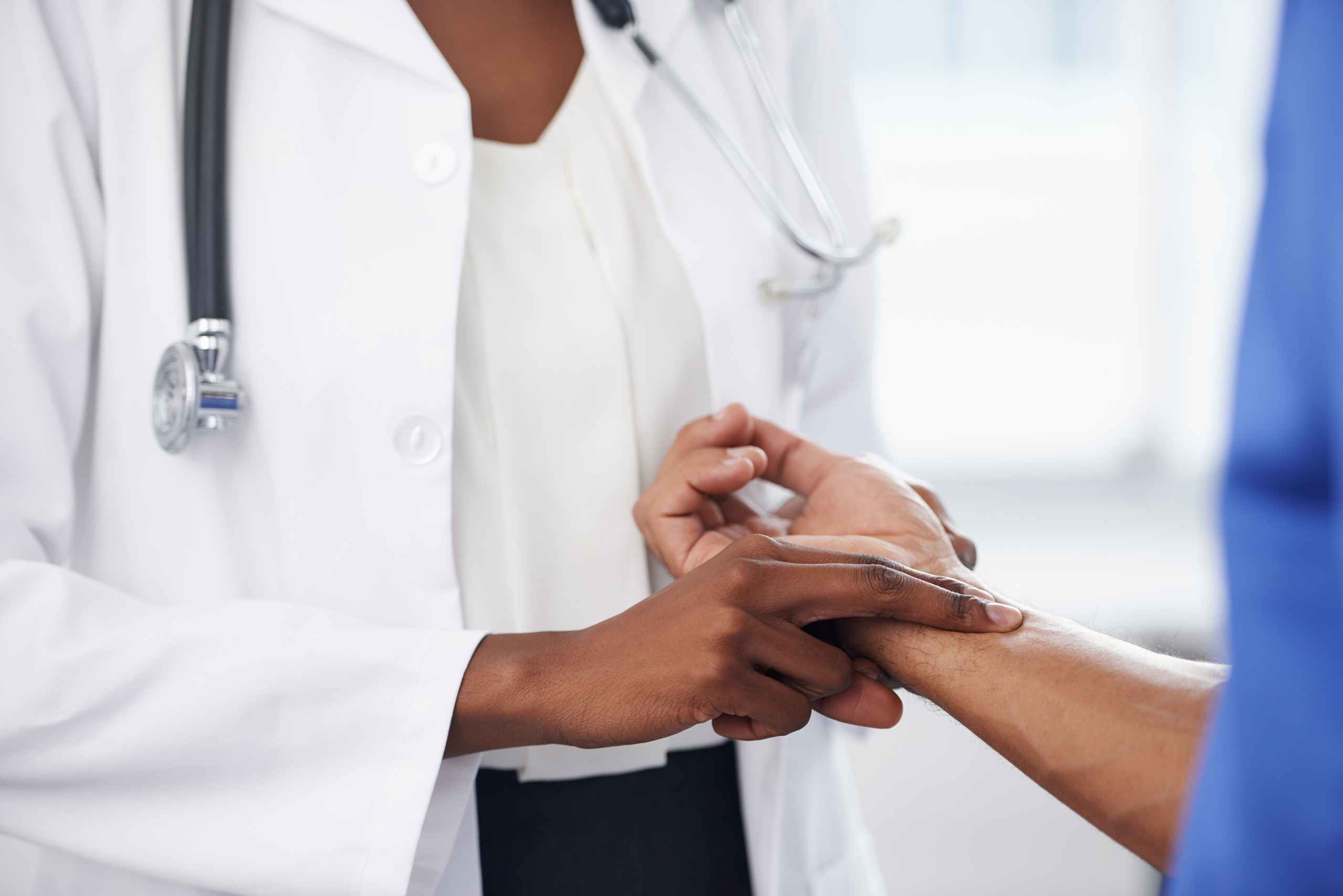 Cropped shot of a doctor checking her patient's pulse