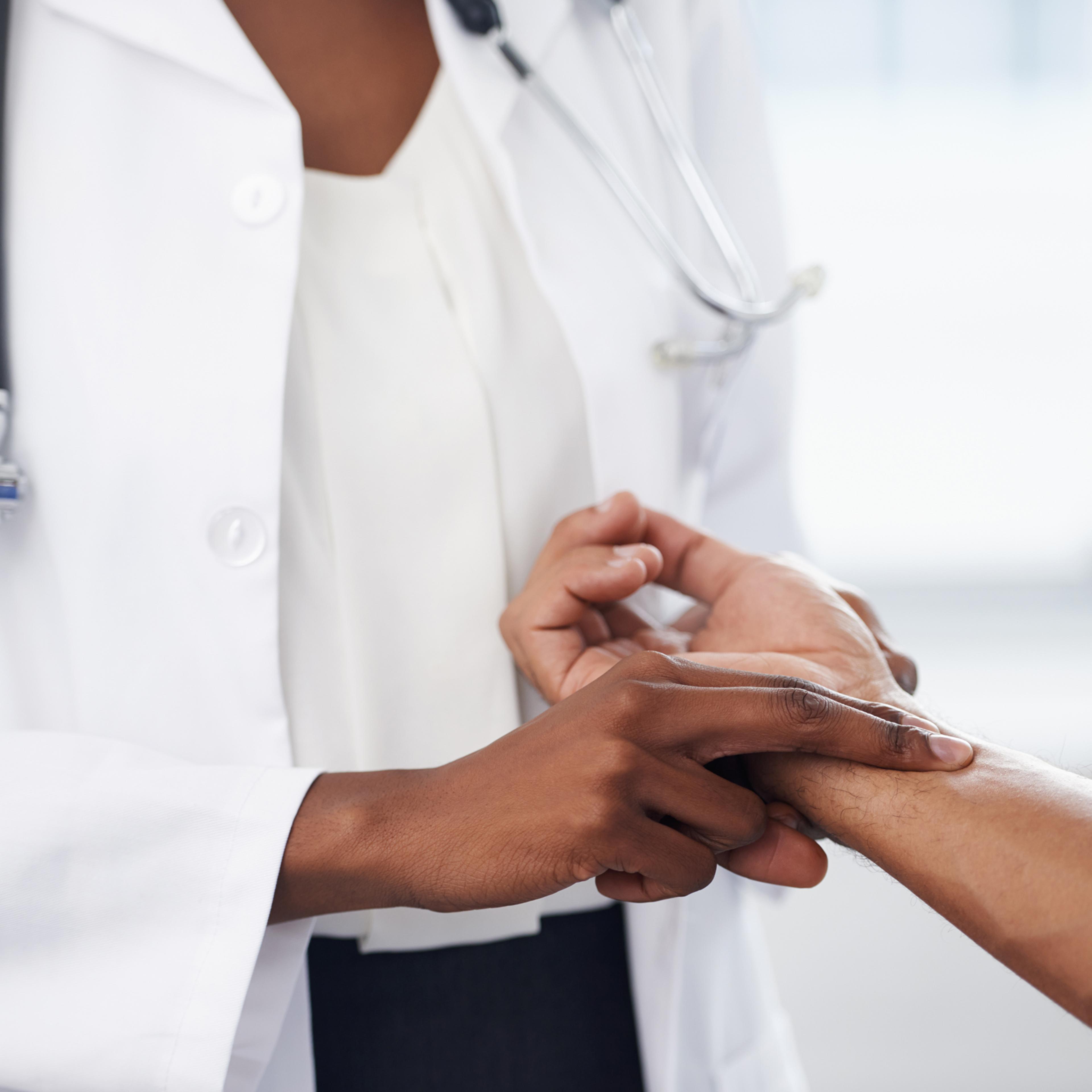 Cropped shot of a doctor checking her patient's pulse