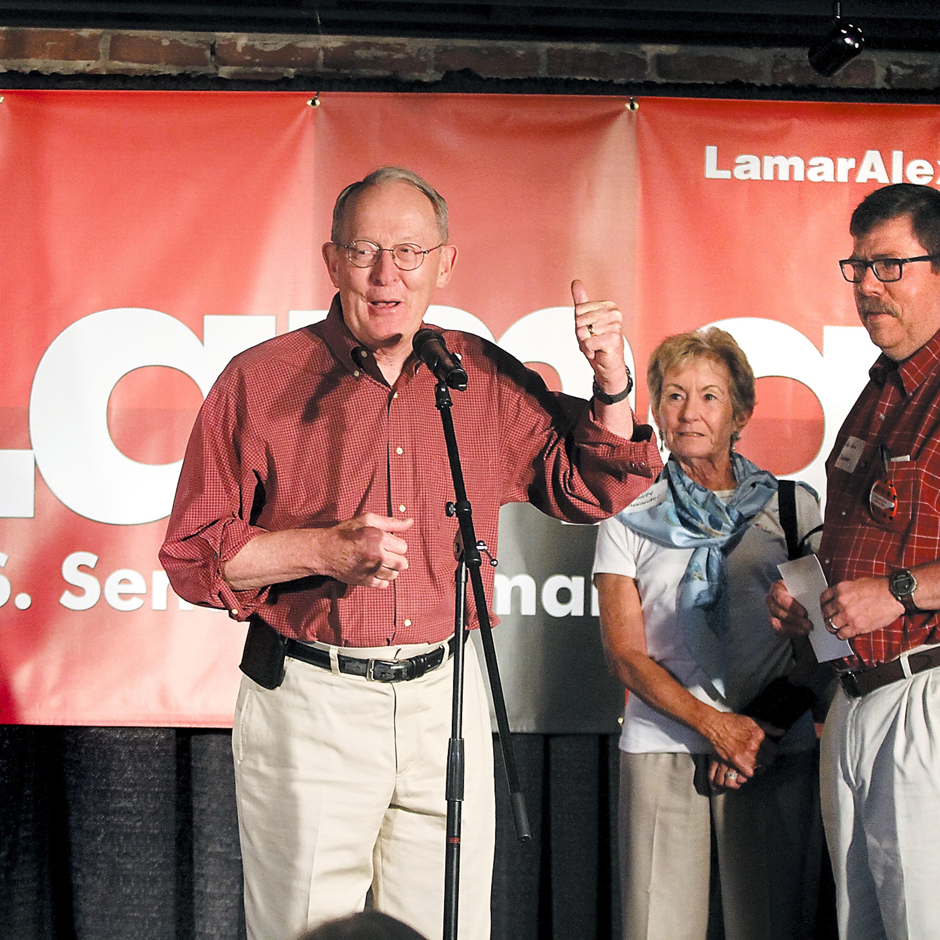 U.S. Senator Lamar Alexander announces the kickoff of his "Standing Up for Tennessee" bus tour at Sullivan's Restaurant in his hometown of Maryville, Tenn., as his wife Honey and State Rep. Art Swann look on on July 25, 2014.