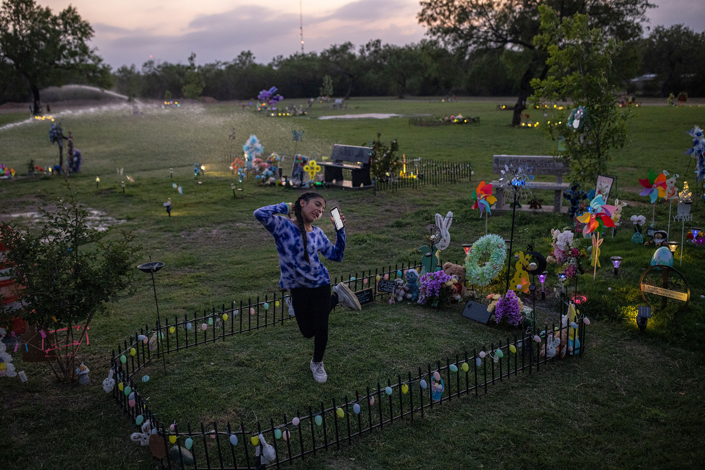 Caitlyne Gonzales, who lost many of her friends in the shooting, sang and danced to Taylor Swift songs at Jacklyn Cazares' grave in Uvalde, Texas, on April 19. One year after 19 children and two teachers were killed at Robb Elementary, the cemetery where