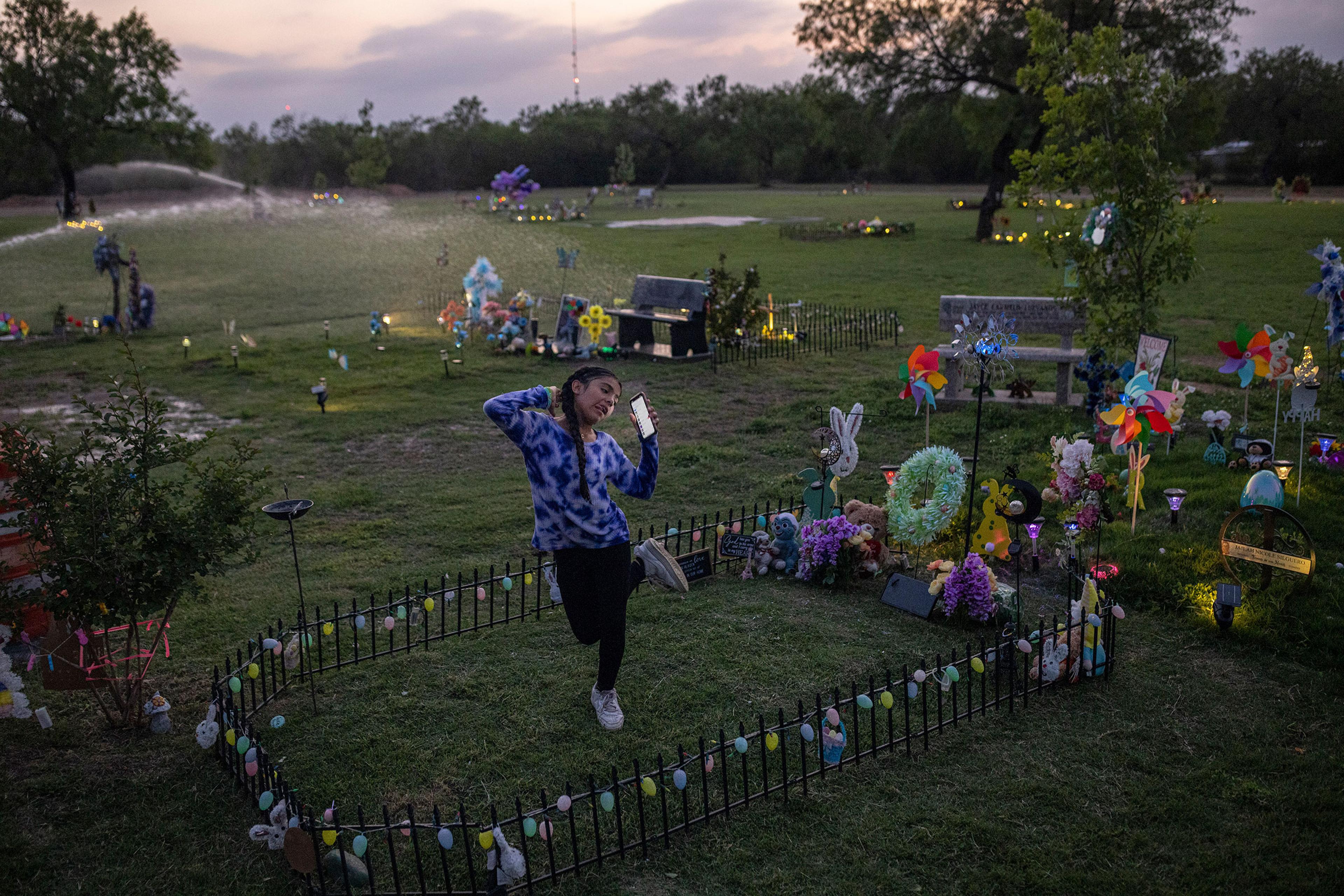 Caitlyne Gonzales, who lost many of her friends in the shooting, sang and danced to Taylor Swift songs at Jacklyn Cazares' grave in Uvalde, Texas, on April 19. One year after 19 children and two teachers were killed at Robb Elementary, the cemetery where