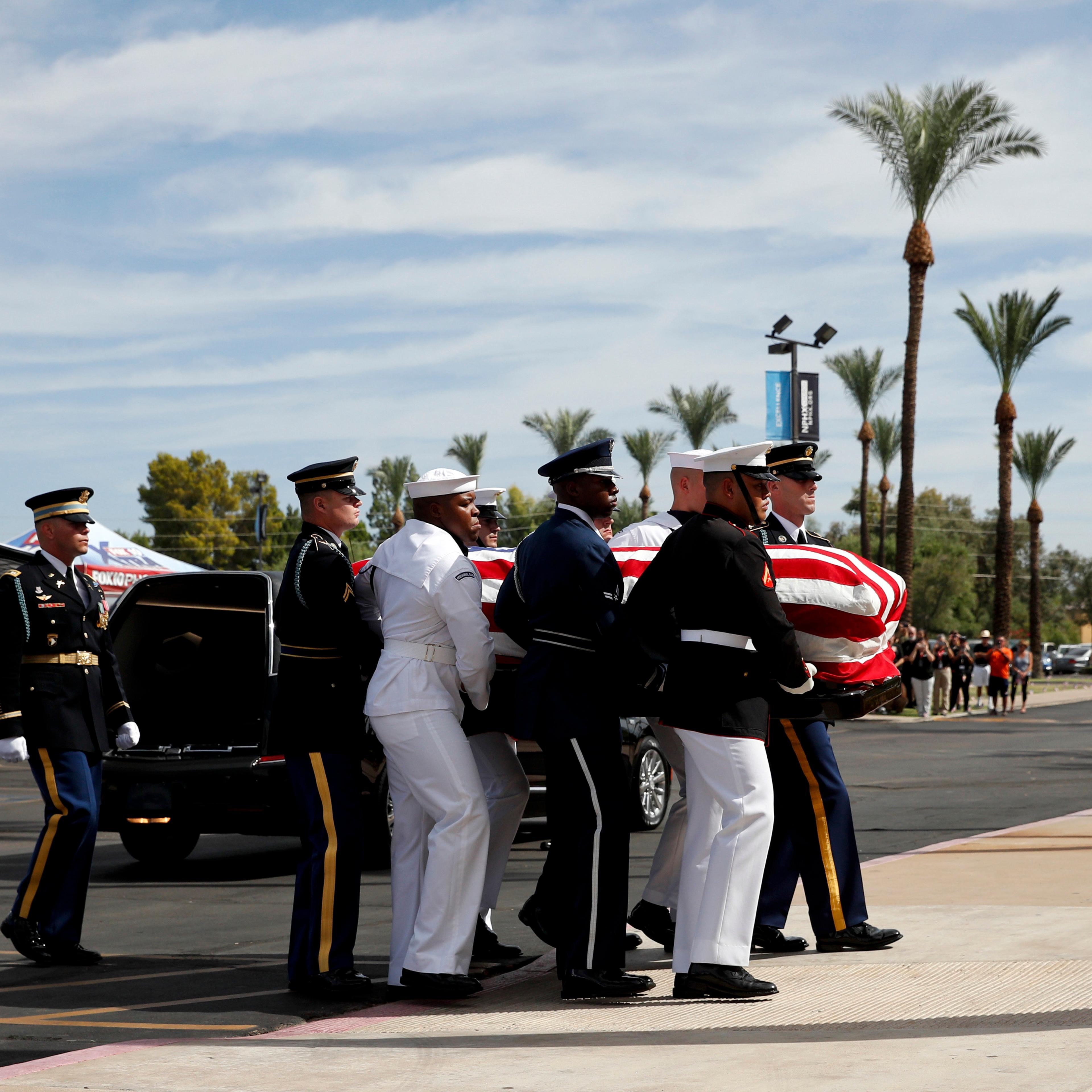 McCain's casket is carried into the church