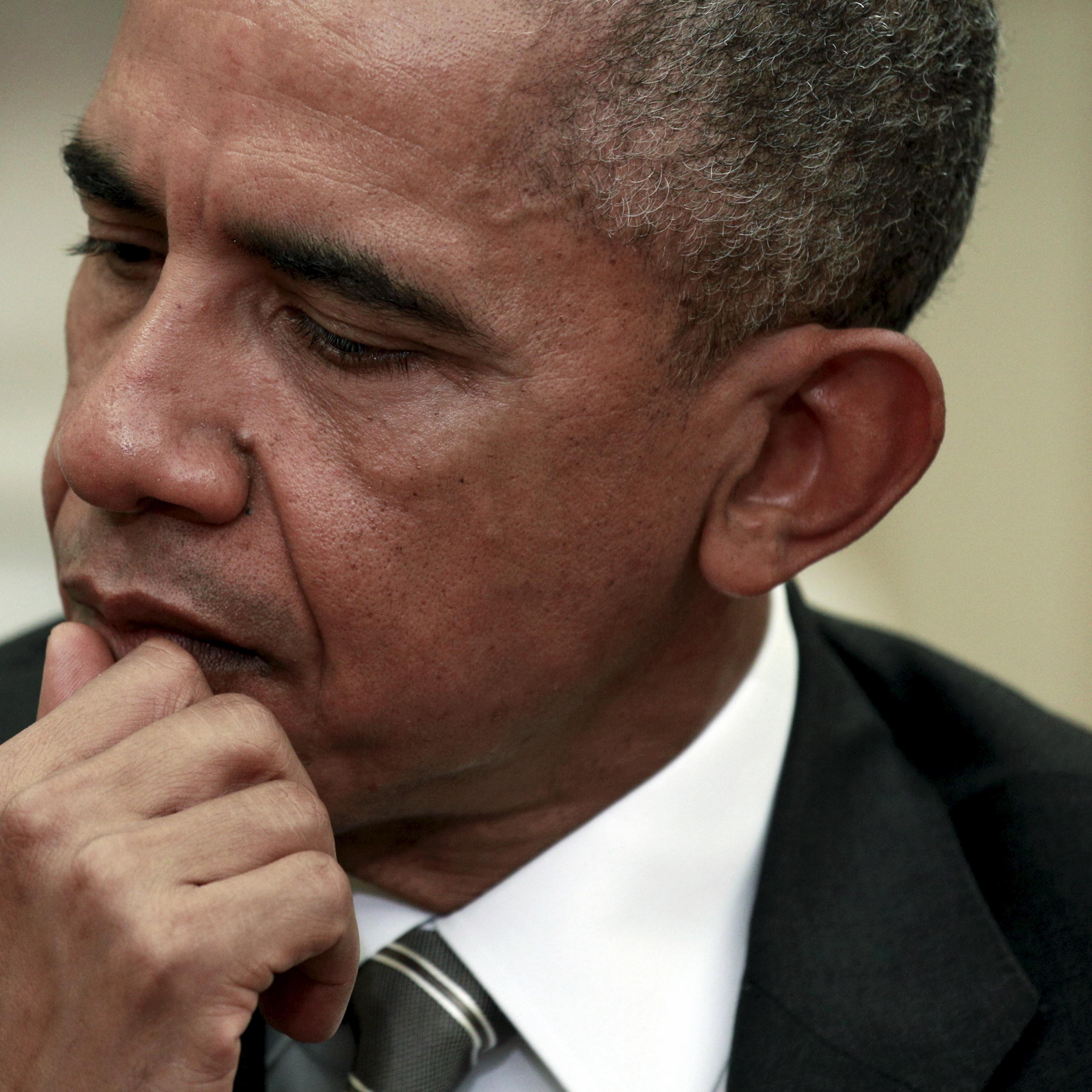U.S. President Barack Obama listens as German President Joachim Gauck speaks during their meeting in the Oval Office of the White House in Washington