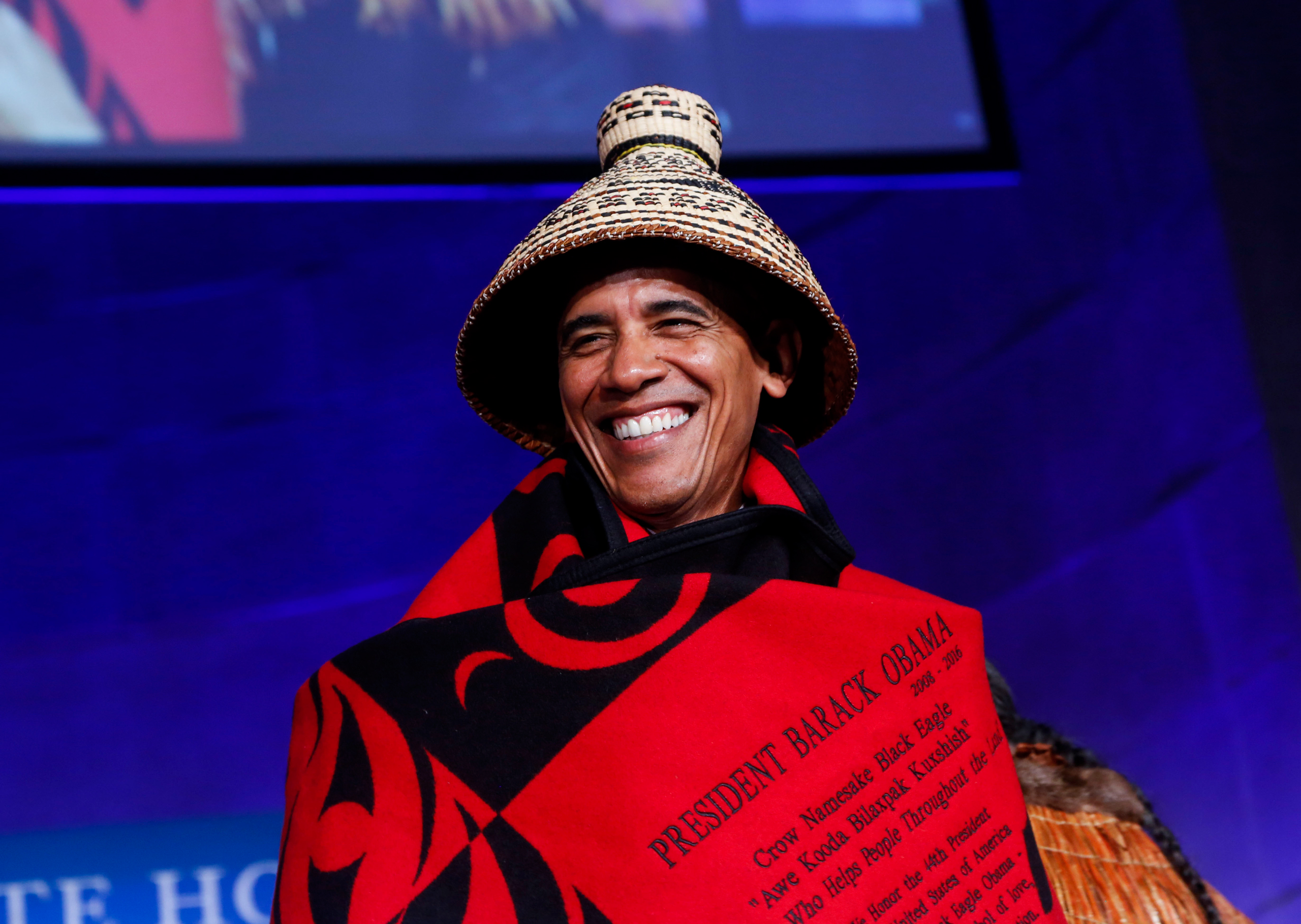 WASHINGTON, DC - SEPTEMBER 26: US President Barack Obama receives a traditional blanket and hat during the 2016 White House Tribal Nations Conference at the Andrew W. Mellon Auditorium, September 26, 2016, Washington, DC. The conference provides tribal l