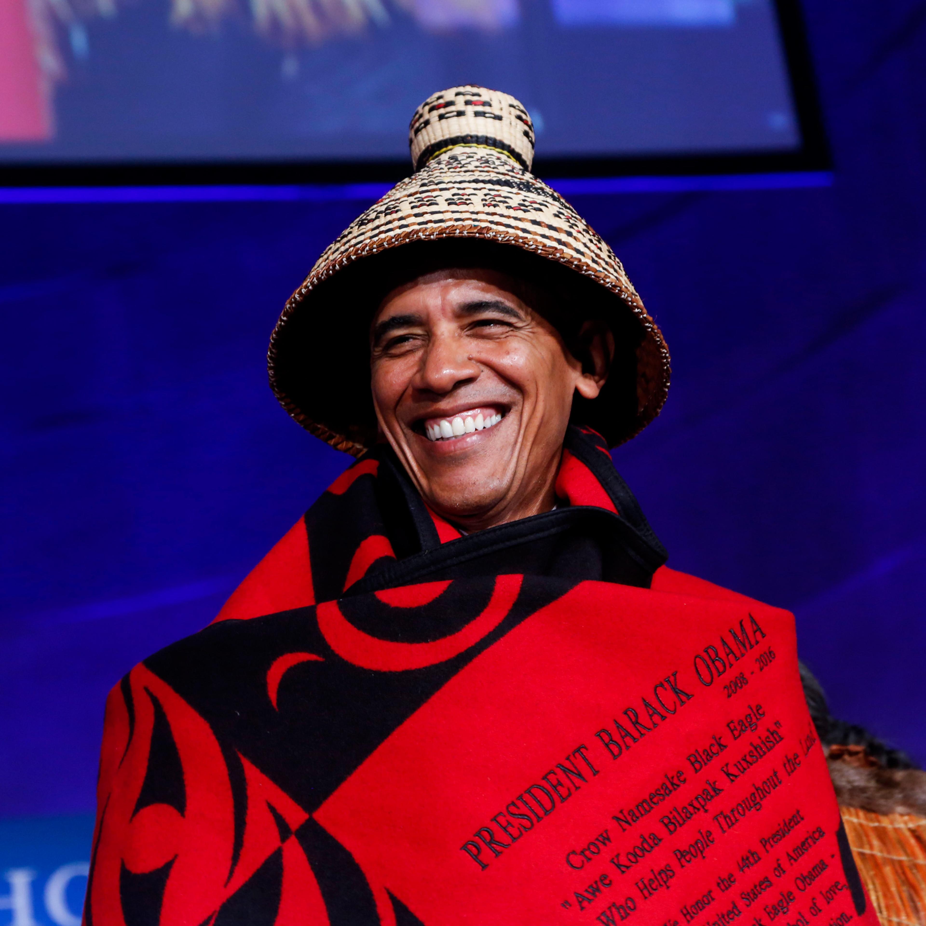 WASHINGTON, DC - SEPTEMBER 26: US President Barack Obama receives a traditional blanket and hat during the 2016 White House Tribal Nations Conference at the Andrew W. Mellon Auditorium, September 26, 2016, Washington, DC. The conference provides tribal l