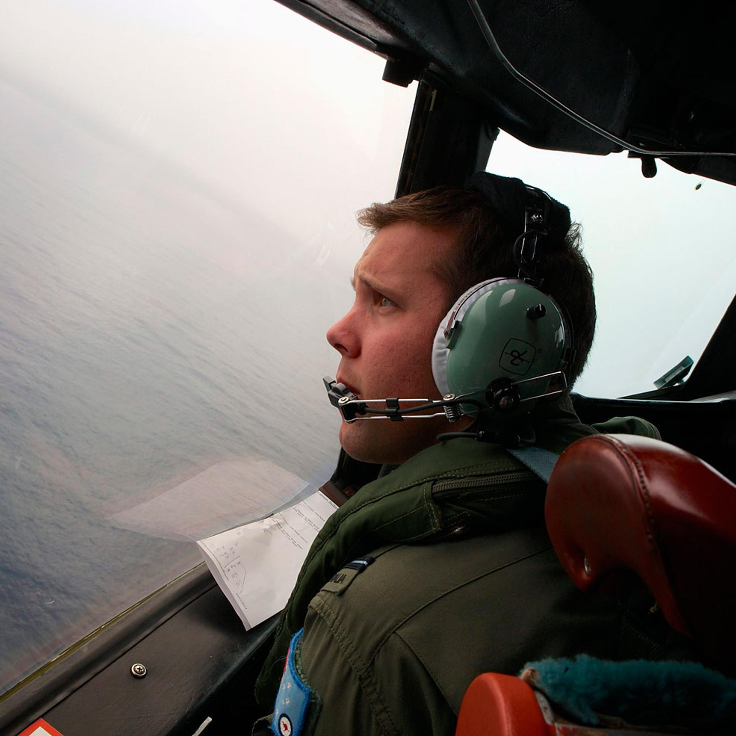 Co-Pilot, Flying Officer Marc Smith, turns his Royal Australian Air Force (RAAF) AP-3C Orion aircraft at low level in bad weather whilst searching for the missing Malaysian Airlines Flight MH370 over the southern Indian Ocean March 24, 2014.