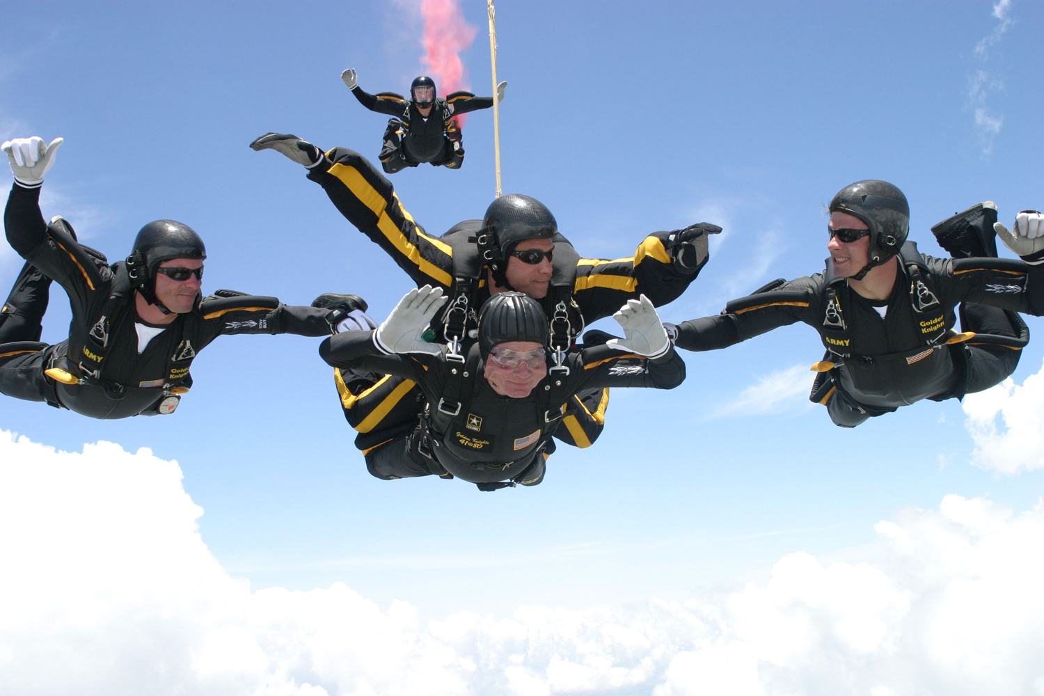 President George H.W. Bush performs a tandem parachute jump with Army Golden Knight Sgt. Bryan Schnell over the Bush Presidential Library in College Station, Texas in 2004.