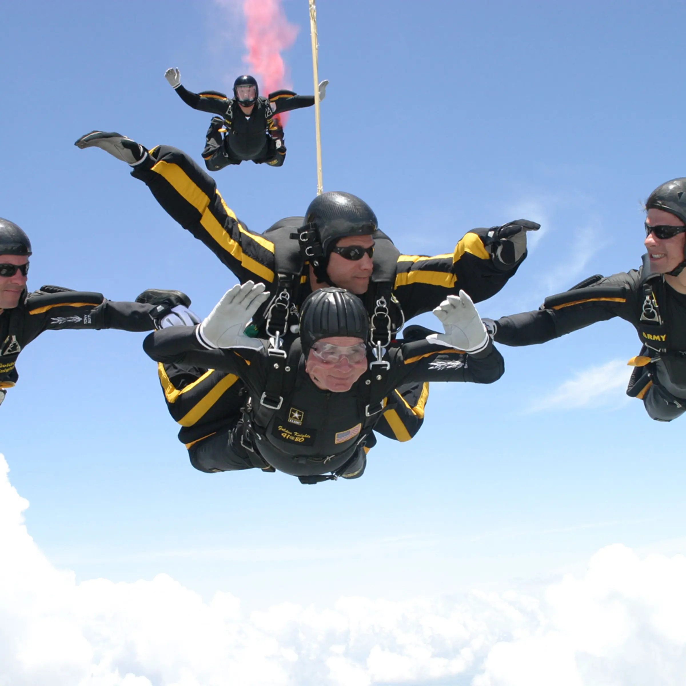 President George H.W. Bush performs a tandem parachute jump with Army Golden Knight Sgt. Bryan Schnell over the Bush Presidential Library in College Station, Texas in 2004.