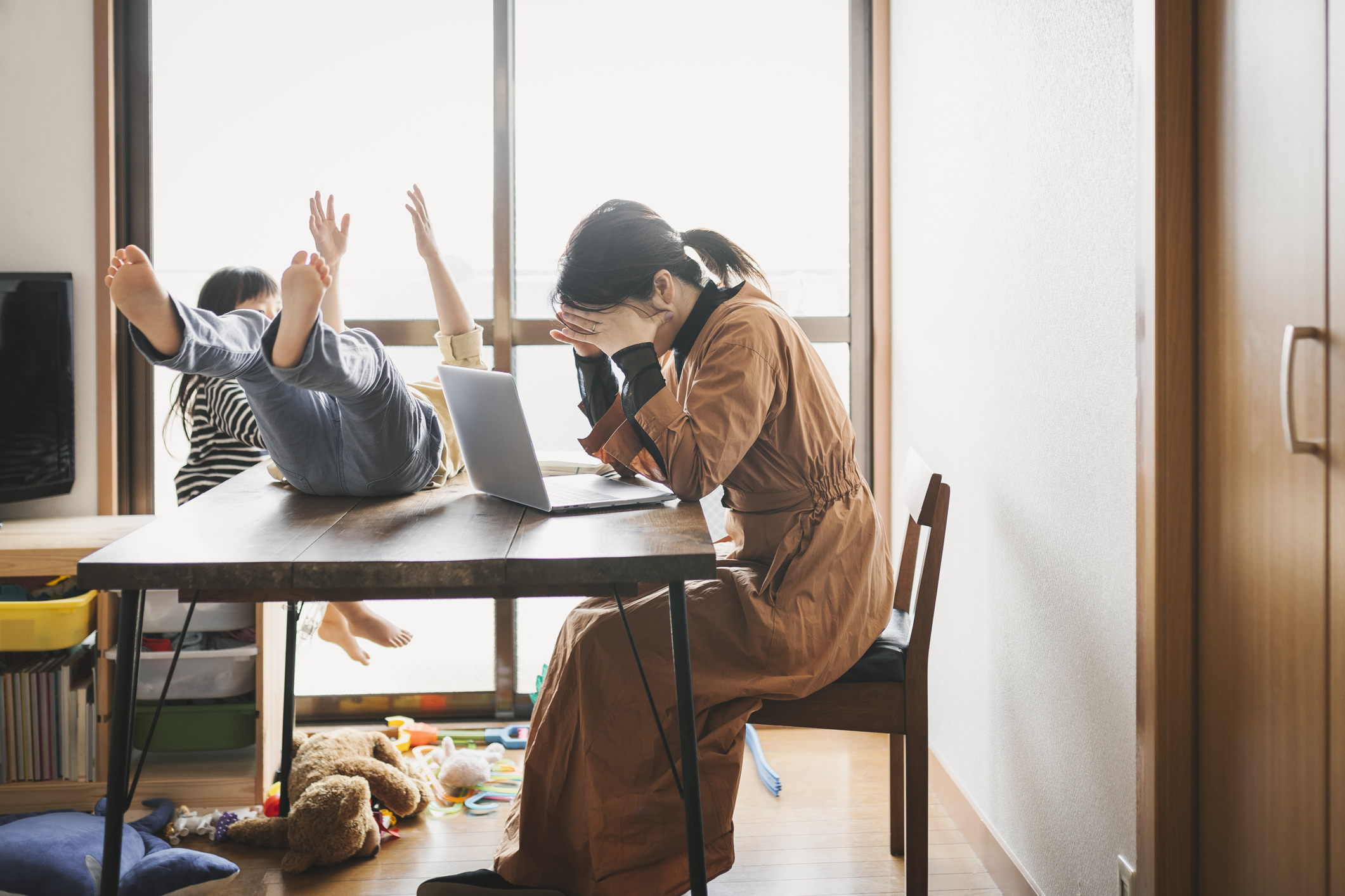 Mother working from home with children