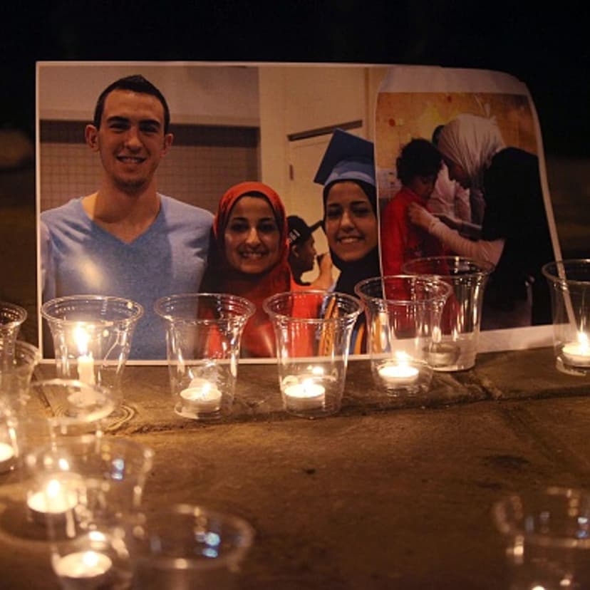 Candles are seen as a group of demonstrators gather in front of American Embassy in Amman to protest against the Chapel Hill shooting, in Amman, Jordan on Feb. 16, 2015.