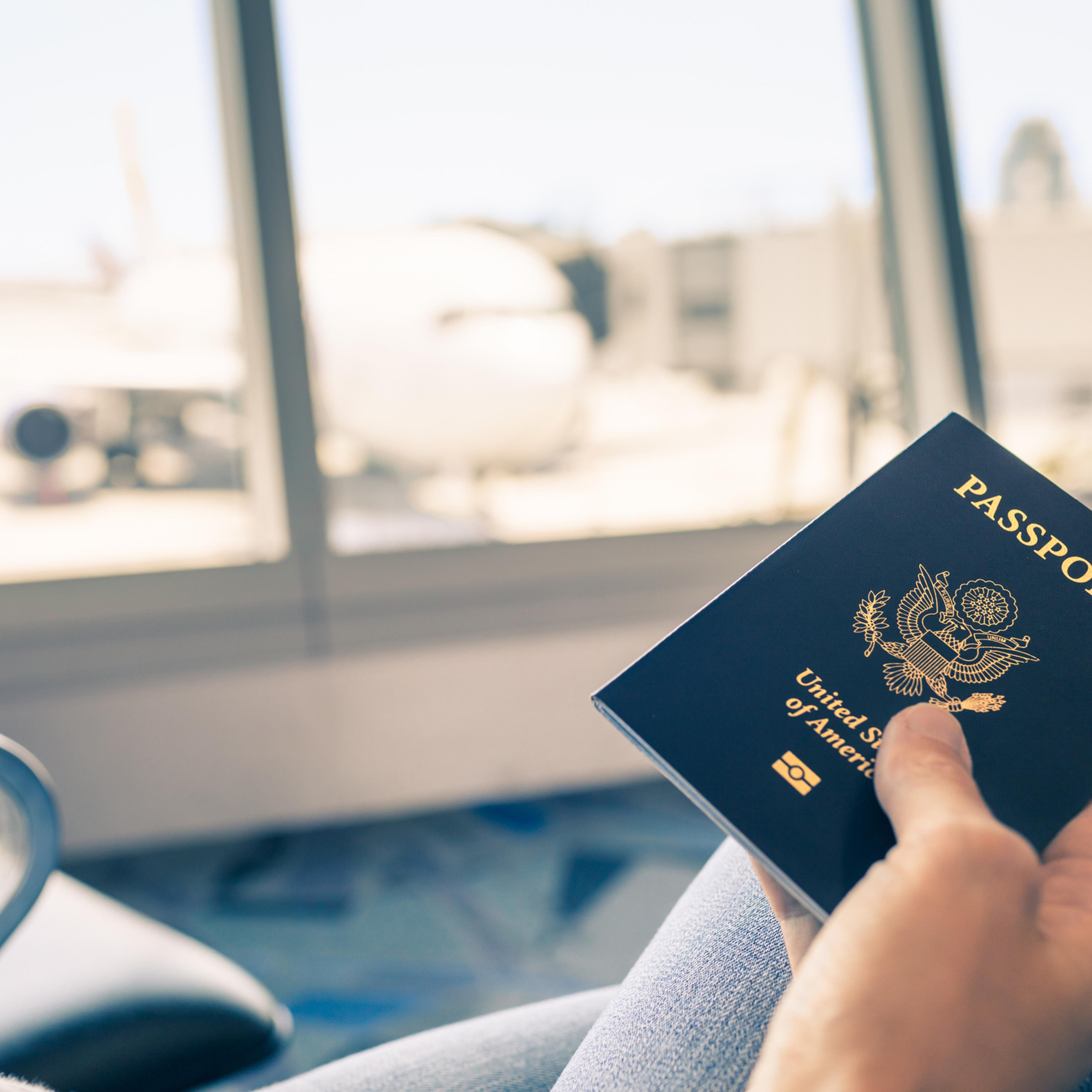 Hand holding US passport.