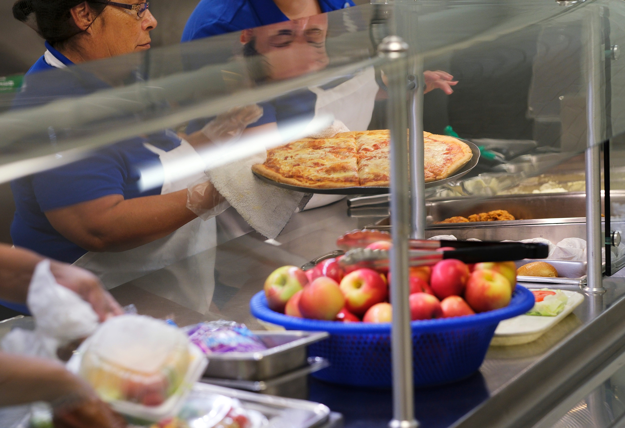 Cafeteria workers set out food at Roosevelt Middle School in Oklahoma, August 11, 2022