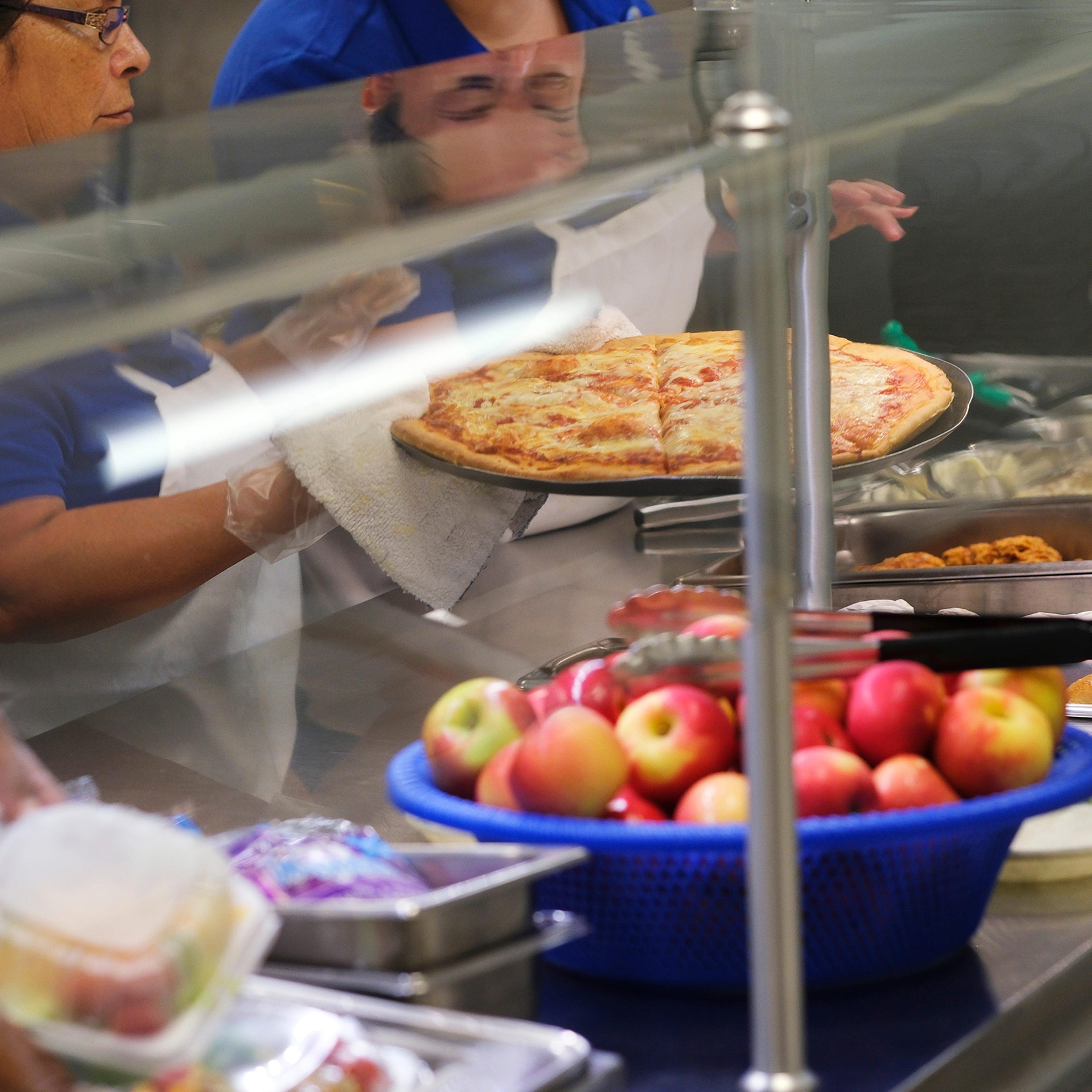 Cafeteria workers set out food at Roosevelt Middle School in Oklahoma, August 11, 2022