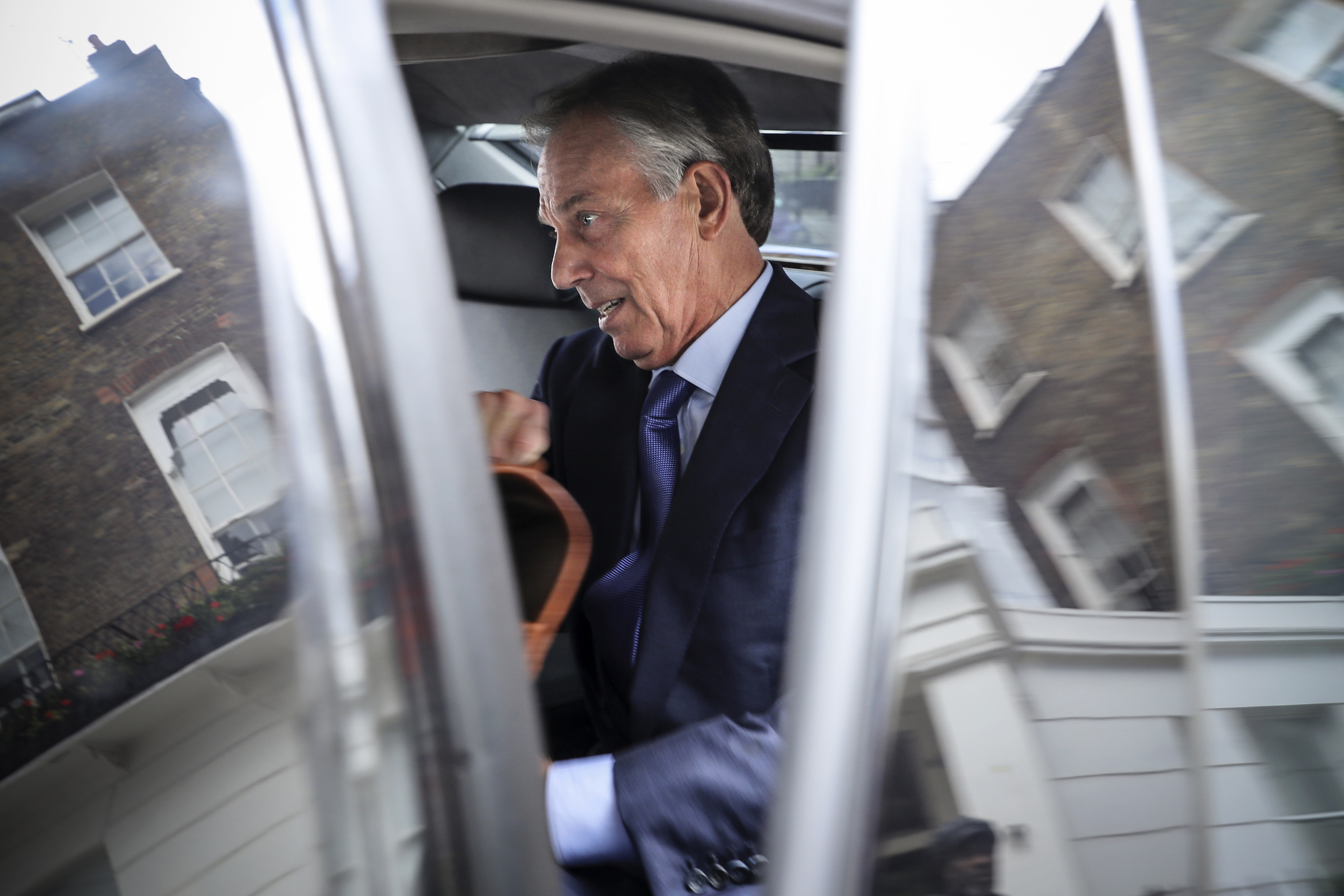 Former British Prime Minister and former Leader of the opposition Labour Party, Tony Blair (right) leaves his Grosvenor Square offices in London on July 5, 2016.