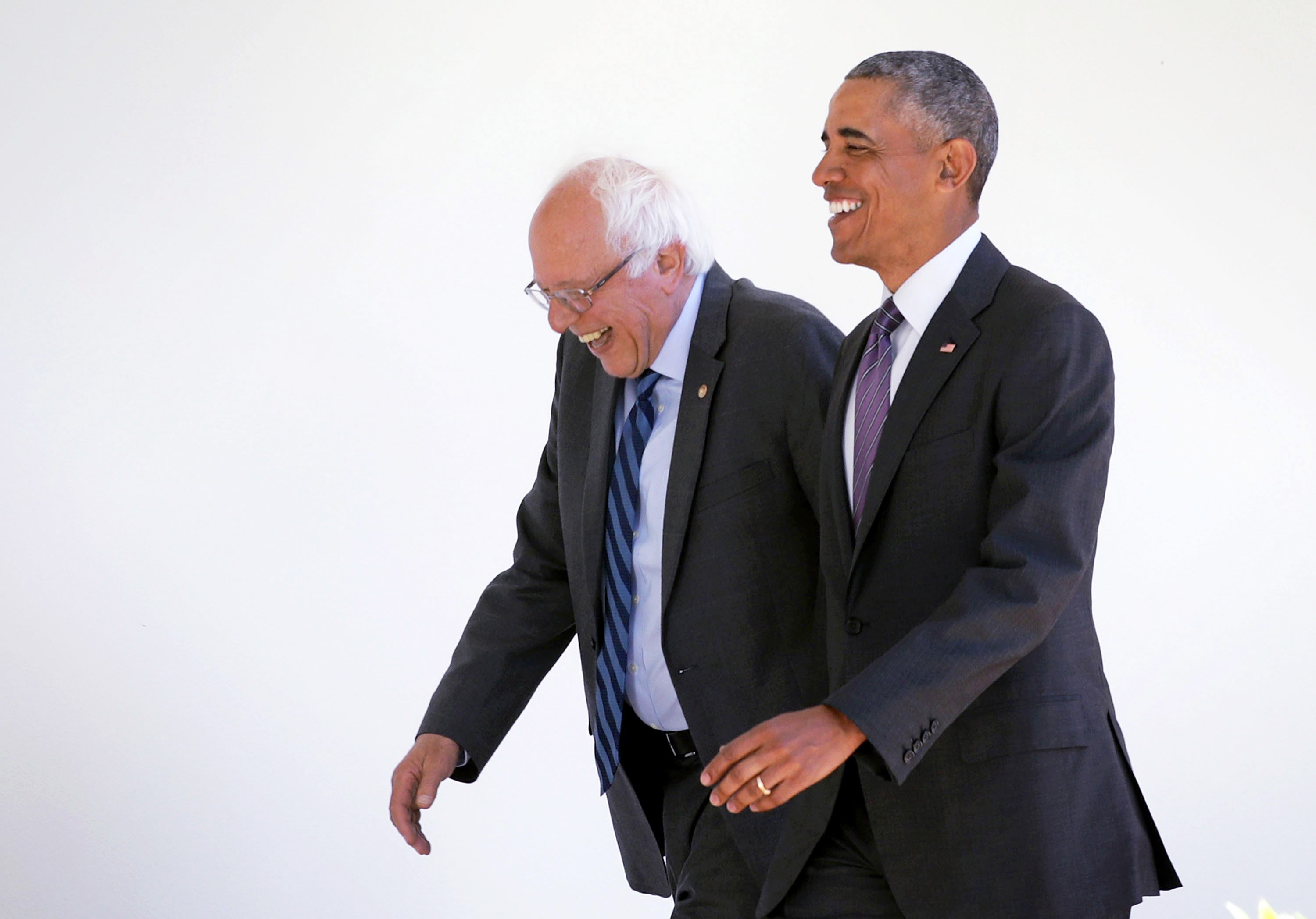 Democratic presidential candidate Sen. Bernie Sanders (D-VT) walks with President Barack Obama through the Colonnade at the White House for an Oval Office meeting June 9, 2016 in Washington.