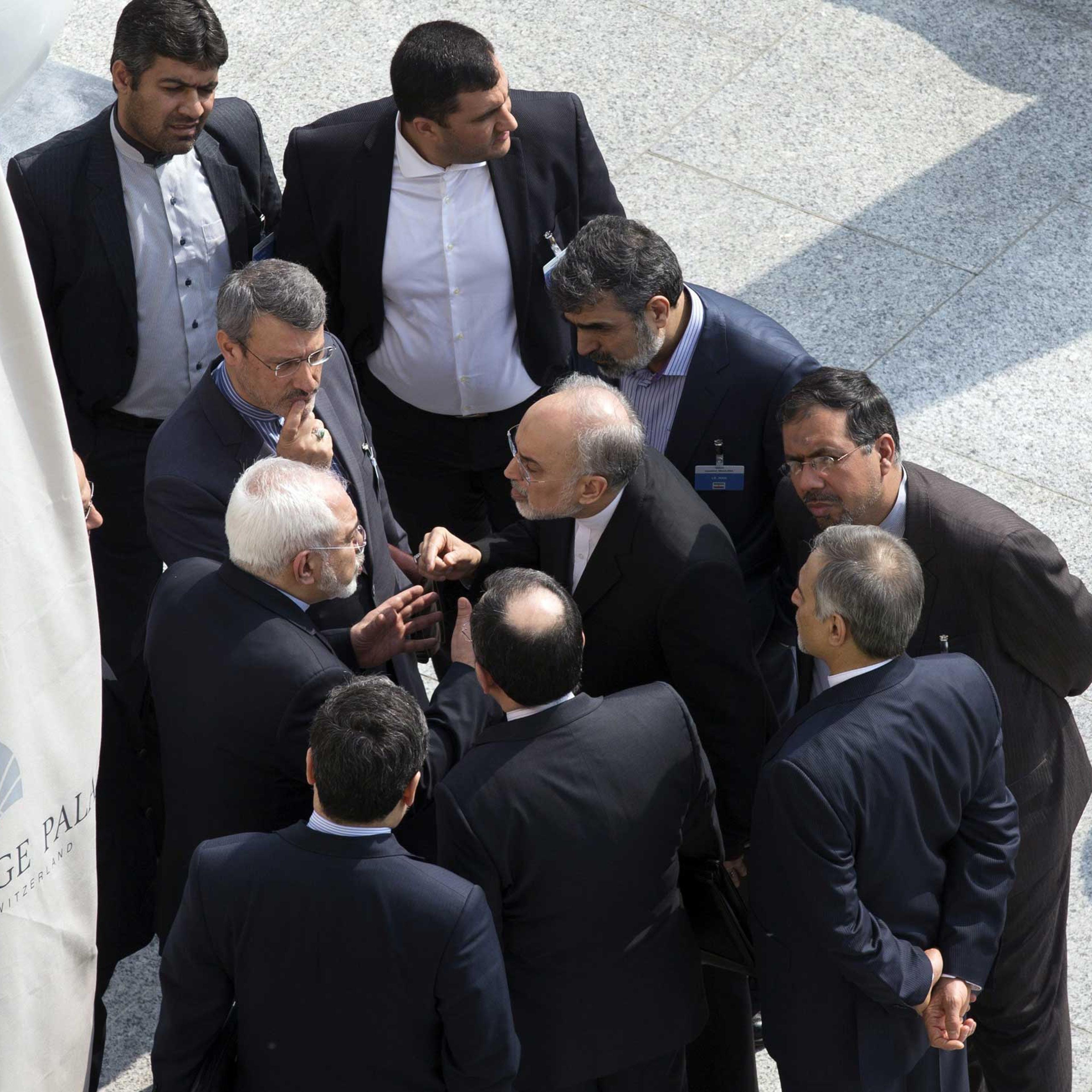 Iran's Foreign Minister Mohammad Javad Zarif, center, and head of the Atomic Energy Organization of Iran Ali Akbar Salehi, center right, talk outside with aides after a morning negotiation session with U.S. Secretary of State John Kerry over Iran's nucle