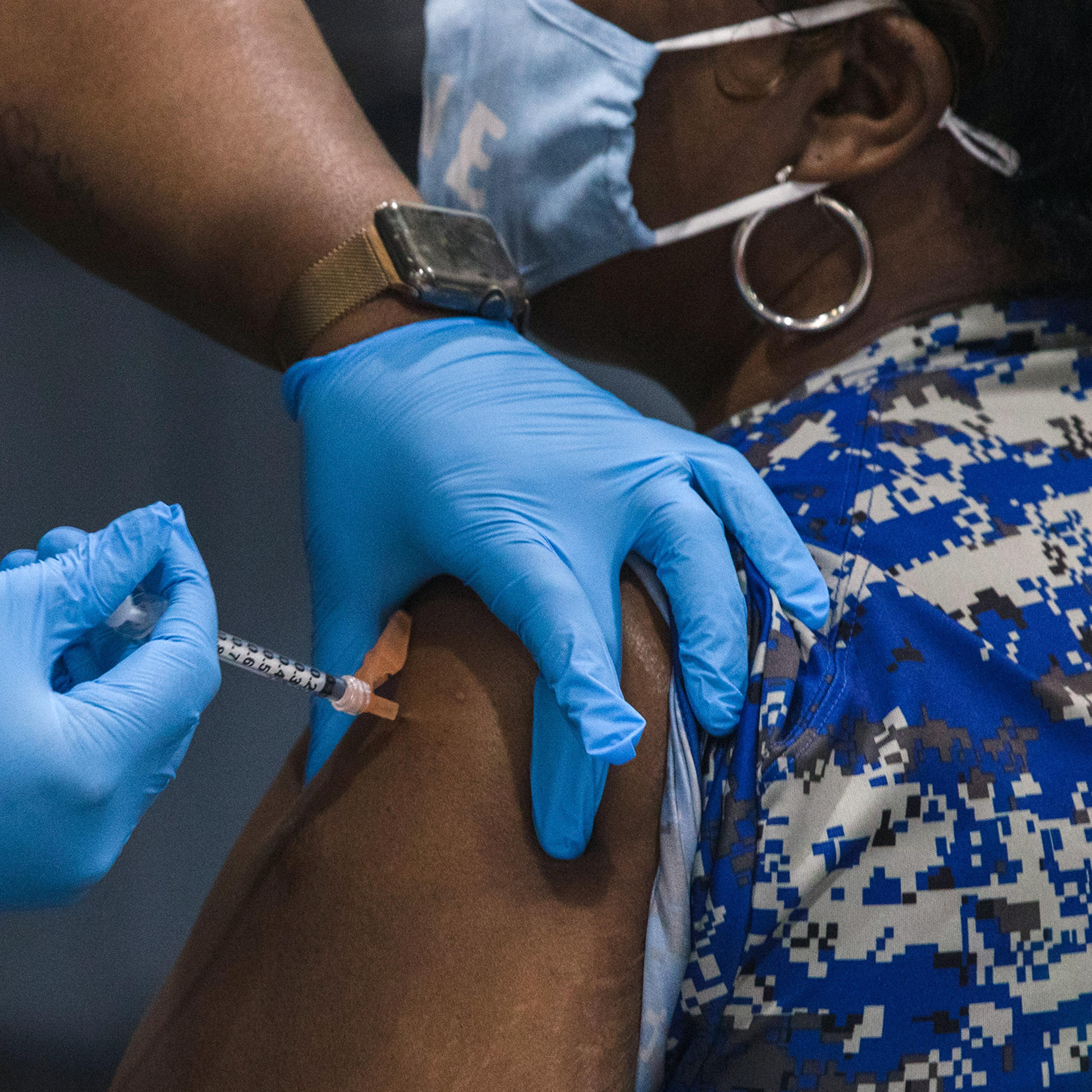 A healthcare worker administers a dose of the Pfizer-BioNTech in South Carolina.
