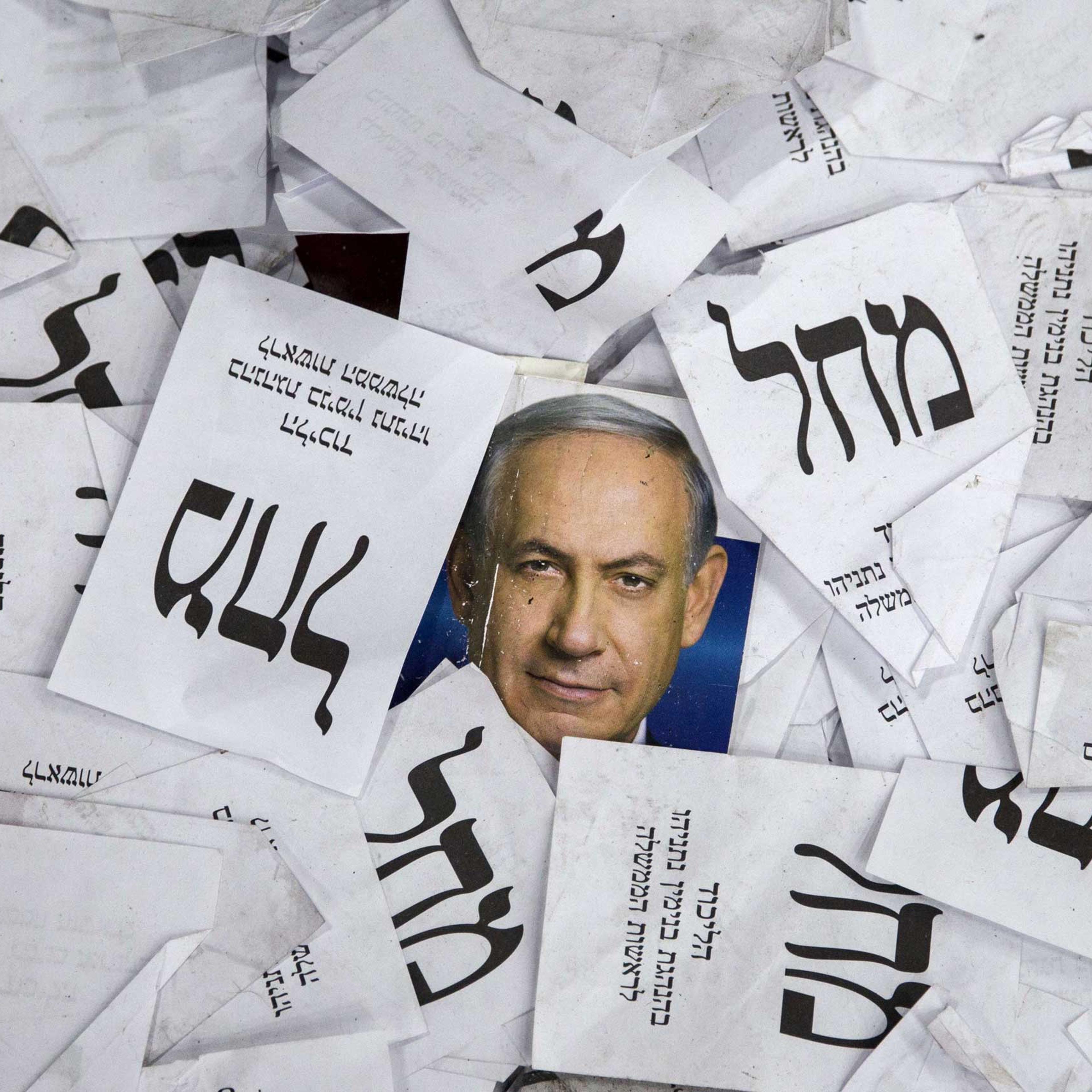Copies of ballots papers and campaign posters for Israel's Prime Minister Benjamin Netanyahu's Likud Party lie on the ground in the aftermath of the country's parliamentary elections in Tel Aviv on March 18, 2015.