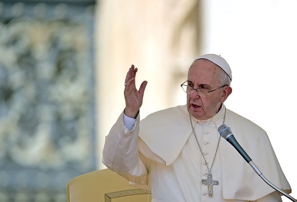 Pope Francis blesses the faithfull as he leads his weekly general audience in Saint Peter's Square at the Vatican on August 26, 2015.