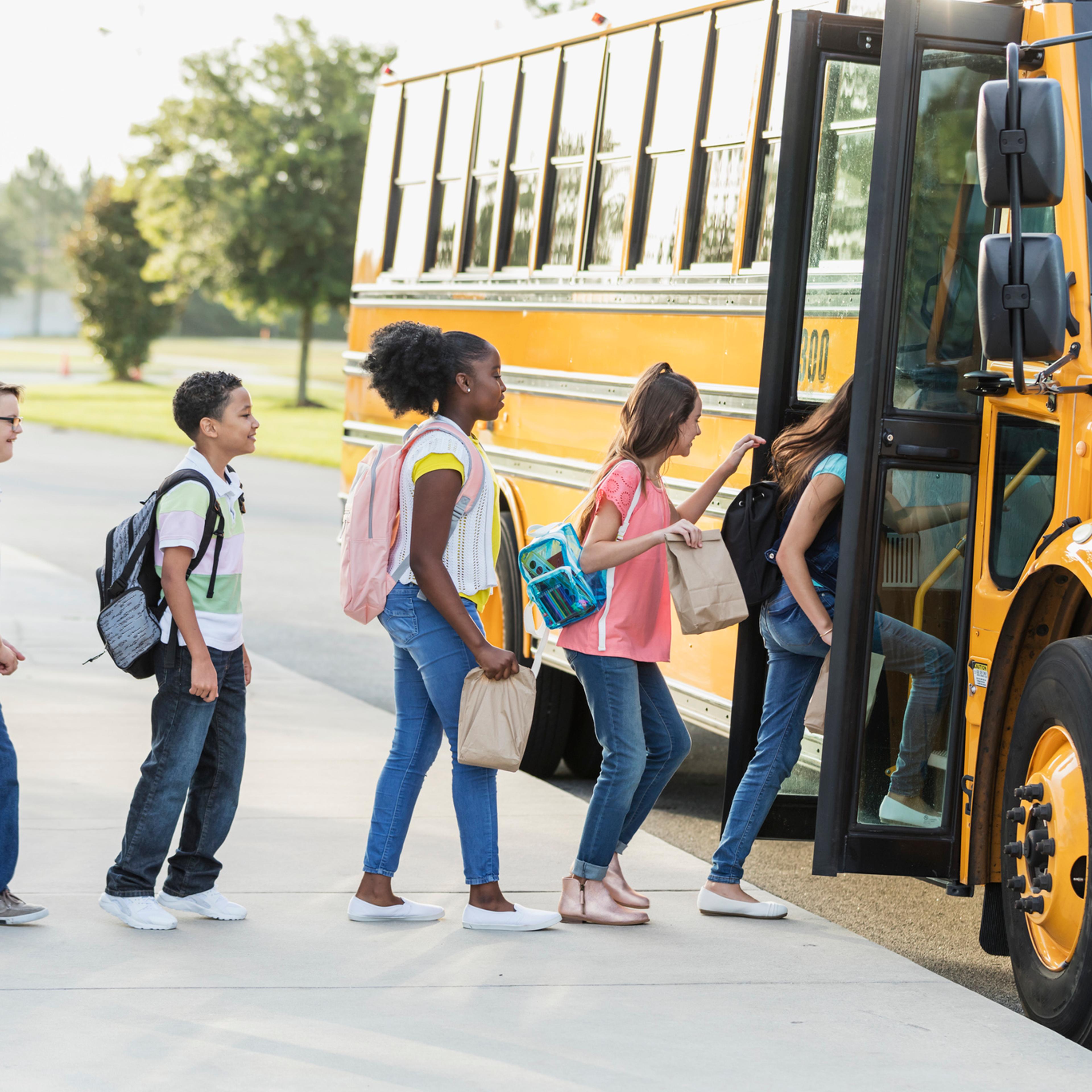 Middle school students boarding a bus
