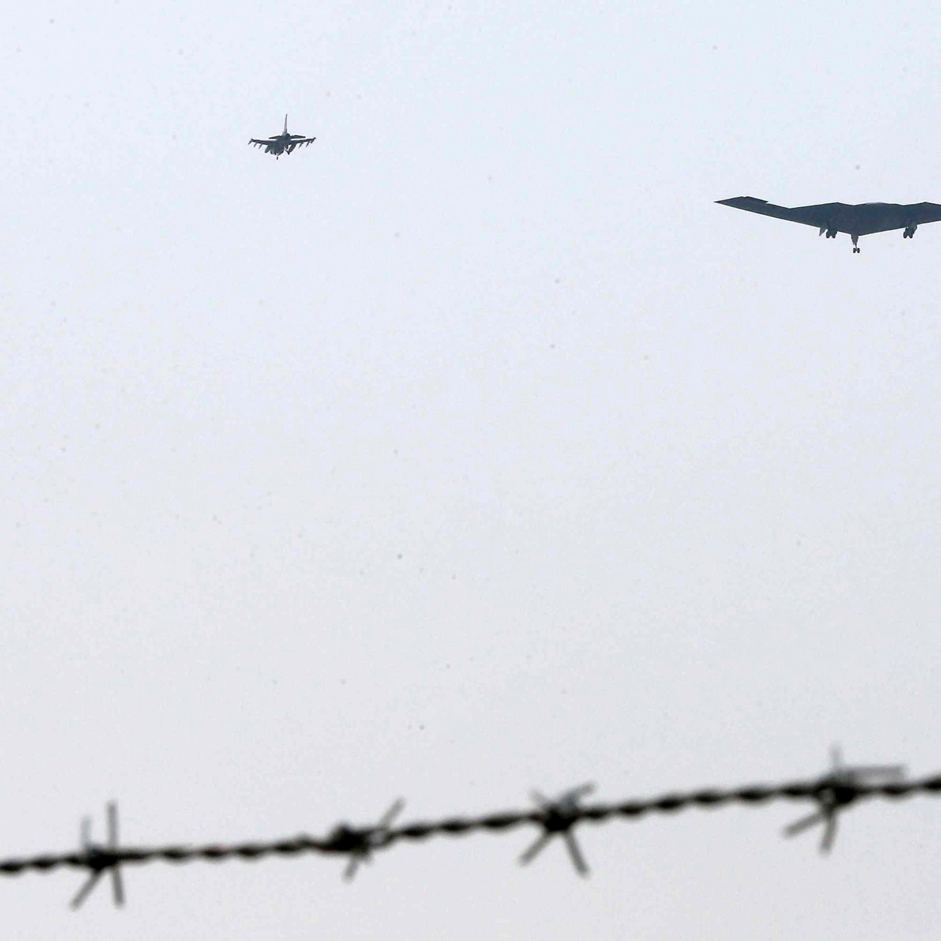 The United States air force's B-2 stealth bomber, center, flies over near the Osan U.S. Air Base in Pyeongtaek, south of Seoul, South Korea, Thursday, March 28, 2013. A day after shutting down a key military hotline, Pyongyang instead used indirect commu