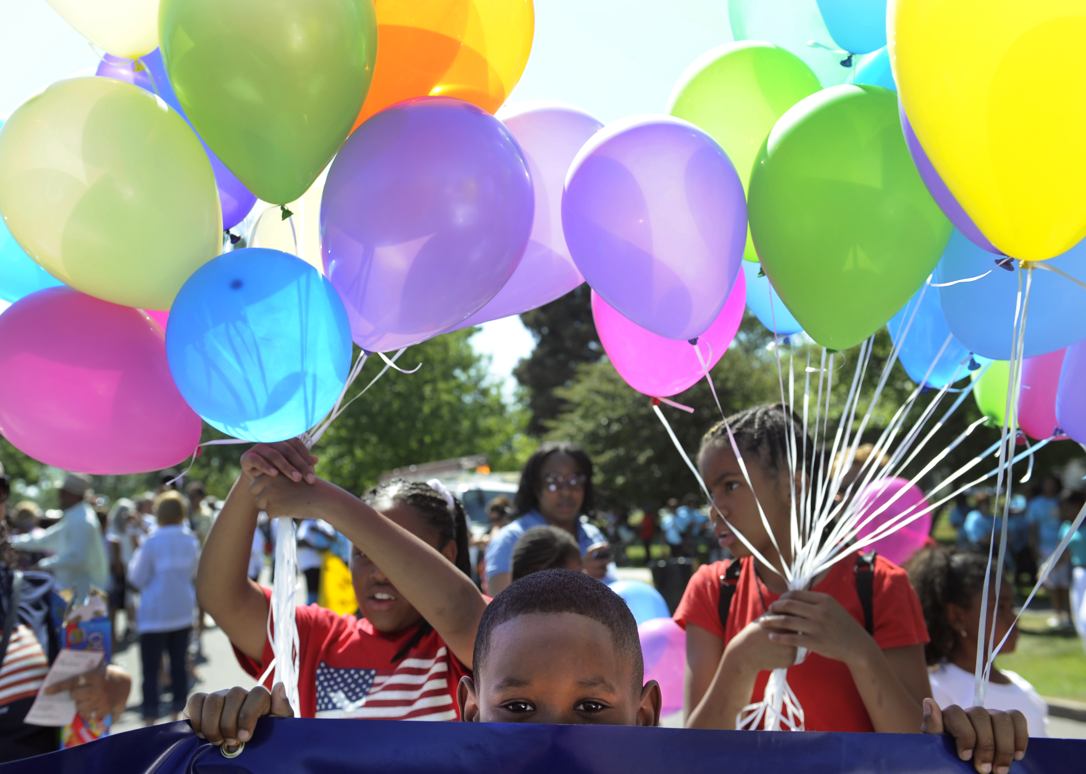 Brian Harris, 8, waits for the parade to begin with his mom and other employees from US Bank. The Friends of Blair Caldwell African American Research Library Foundation hosts the 2011 Denver Juneteenth Celebration: We Define Who We Are, on Saturday, June
