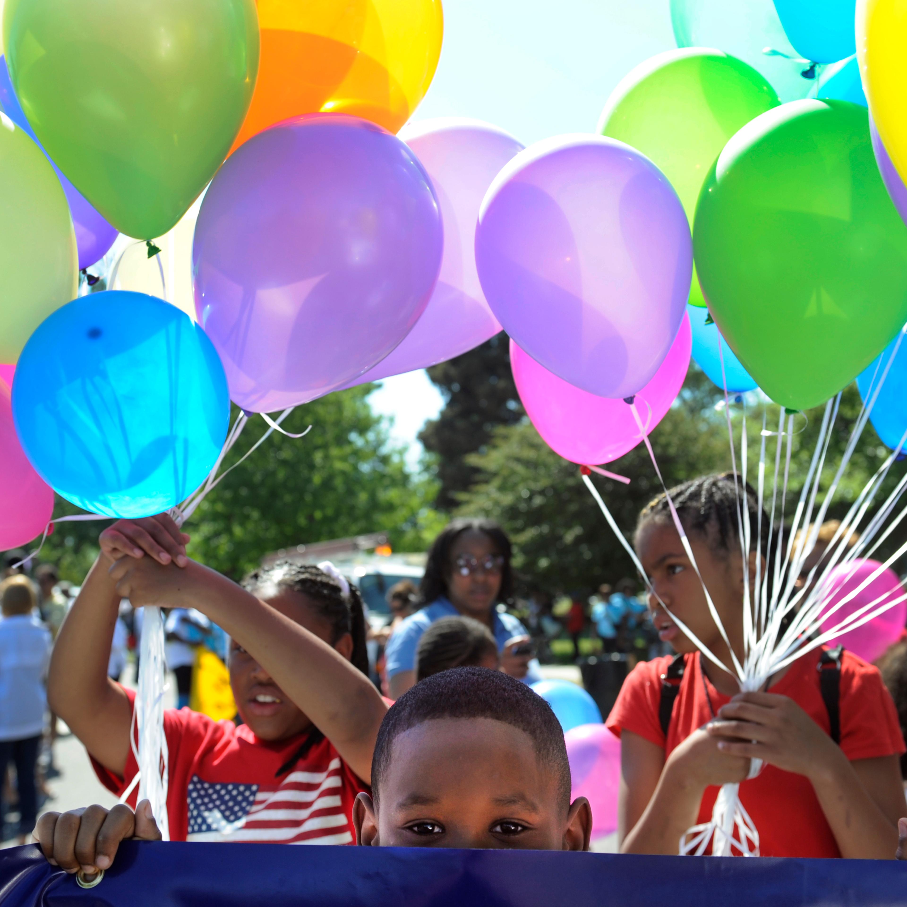 Brian Harris, 8, waits for the parade to begin with his mom and other employees from US Bank. The Friends of Blair Caldwell African American Research Library Foundation hosts the 2011 Denver Juneteenth Celebration: We Define Who We Are, on Saturday, June